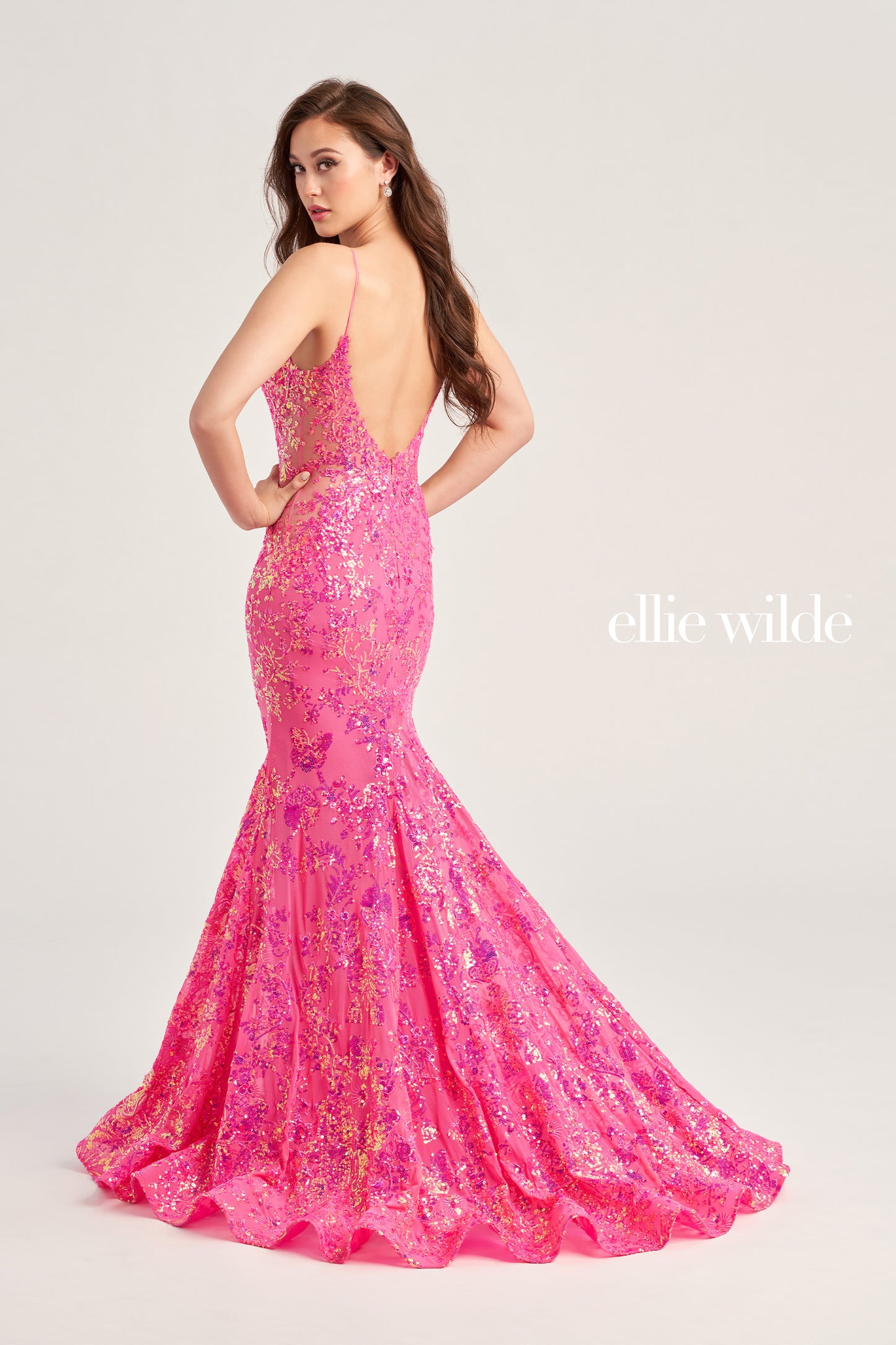 The Ellie Wilde EW35015 is a unique showstopper, featuring a fitted sequin stretch mesh fabric with a long length, scoop neckline, mermaid silhouette, sleeveless design, open back and natural waistline. Perfect for pageants, prom or any special occasion.  COLOR: MIDNIGHT, LIGHT BLUE, LILAC, HOT PINK SIZE: 00 - 16