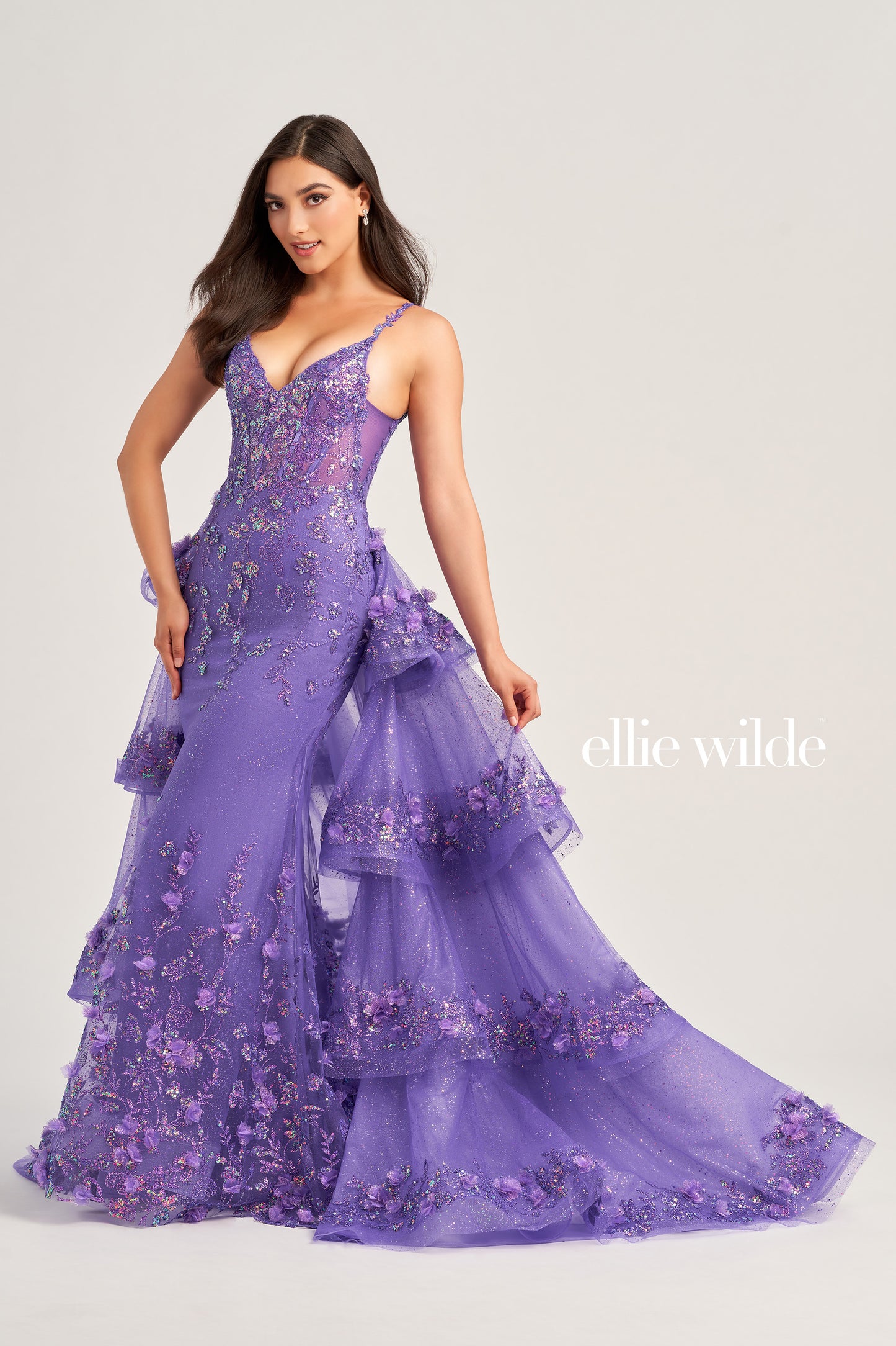 Look and feel your best in the Ellie Wilde EW35045 Prom Dress. This stunning piece features a sheer corset bodice with sequin and 3D Floral Lace accents, a detachable layered  train, three-dimensional flowers, and a glitter tulle skirt. The dress is constructed with cracked ice, sequin, and delicate lace-up back for a truly memorable look.  COLOR: LIGHT BLUE, MAGENTA, LILAC, IRIS SIZE: 00 - 16