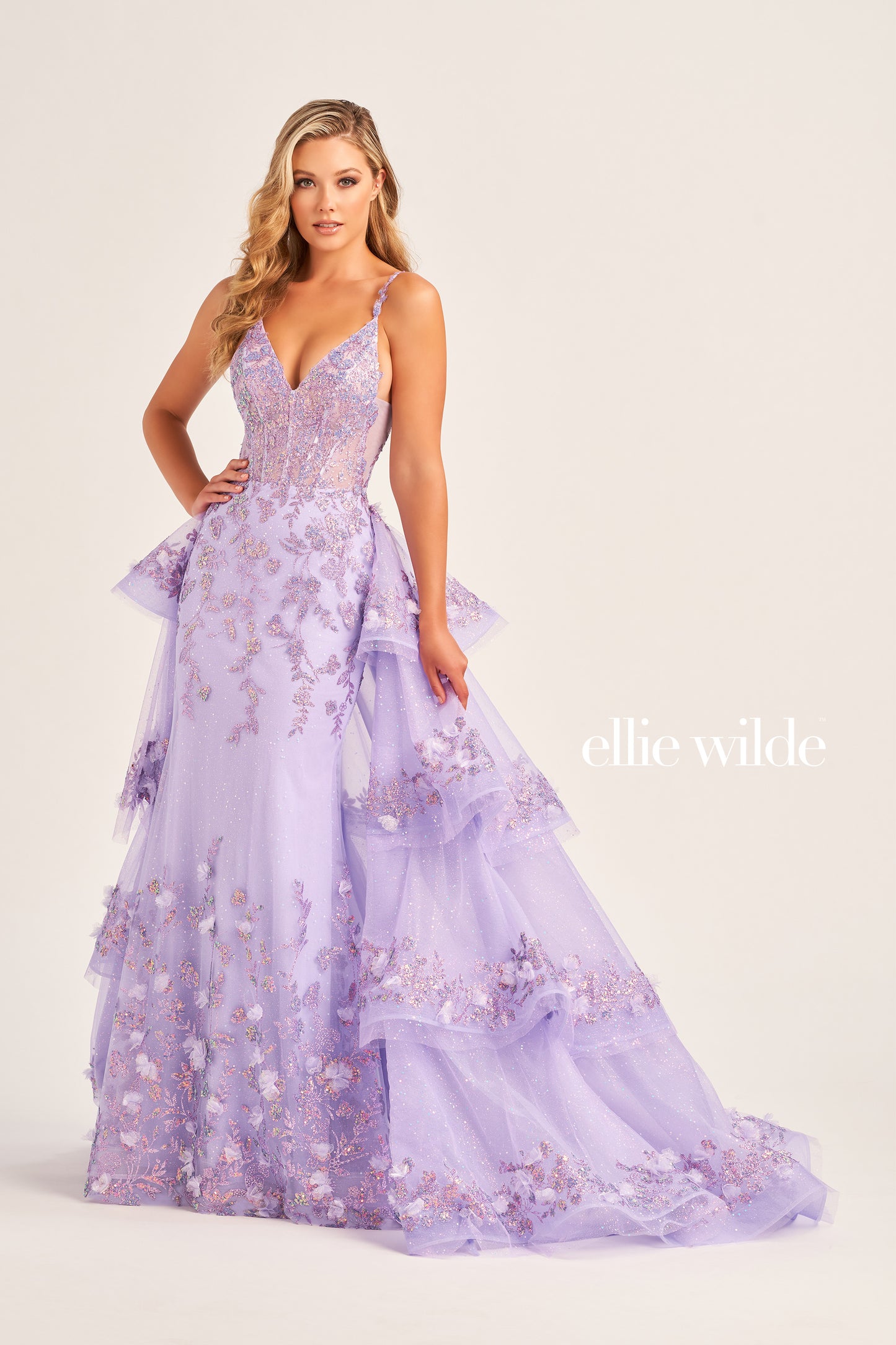 Look and feel your best in the Ellie Wilde EW35045 Prom Dress. This stunning piece features a sheer corset bodice with sequin and 3D Floral Lace accents, a detachable layered  train, three-dimensional flowers, and a glitter tulle skirt. The dress is constructed with cracked ice, sequin, and delicate lace-up back for a truly memorable look.  COLOR: LIGHT BLUE, MAGENTA, LILAC, IRIS SIZE: 00 - 16