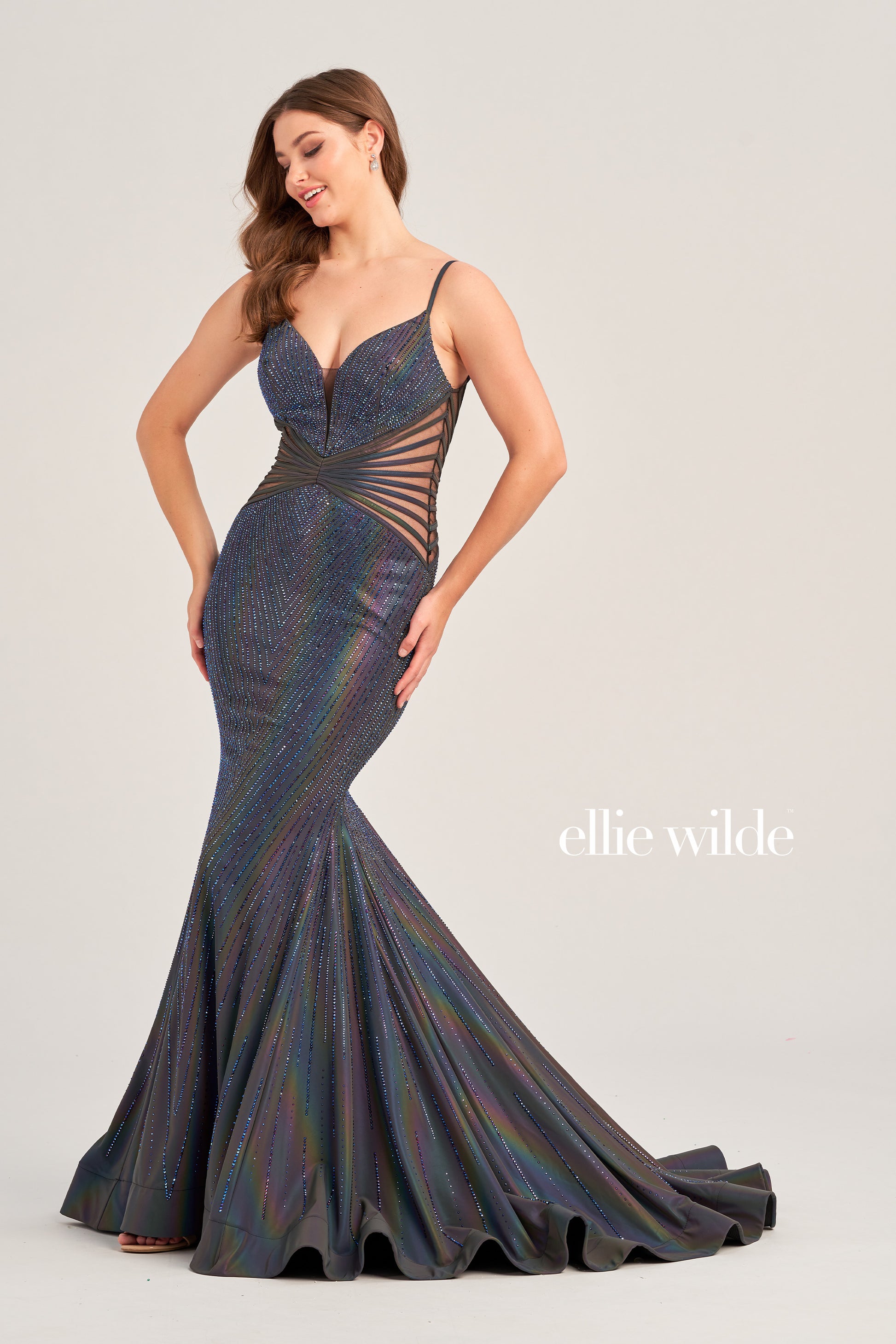 The Ellie Wilde EW35704 Prom Dress is a show-stopping style perfect for any special occasion. Featuring a long, fitted SUPERNOVA mermaid silhouette, sheer bodice with boning, this holographic gown is sure to turn heads. A unique style for a memorable night.   Sizes: 00-24  Colors: SUPERNOVA