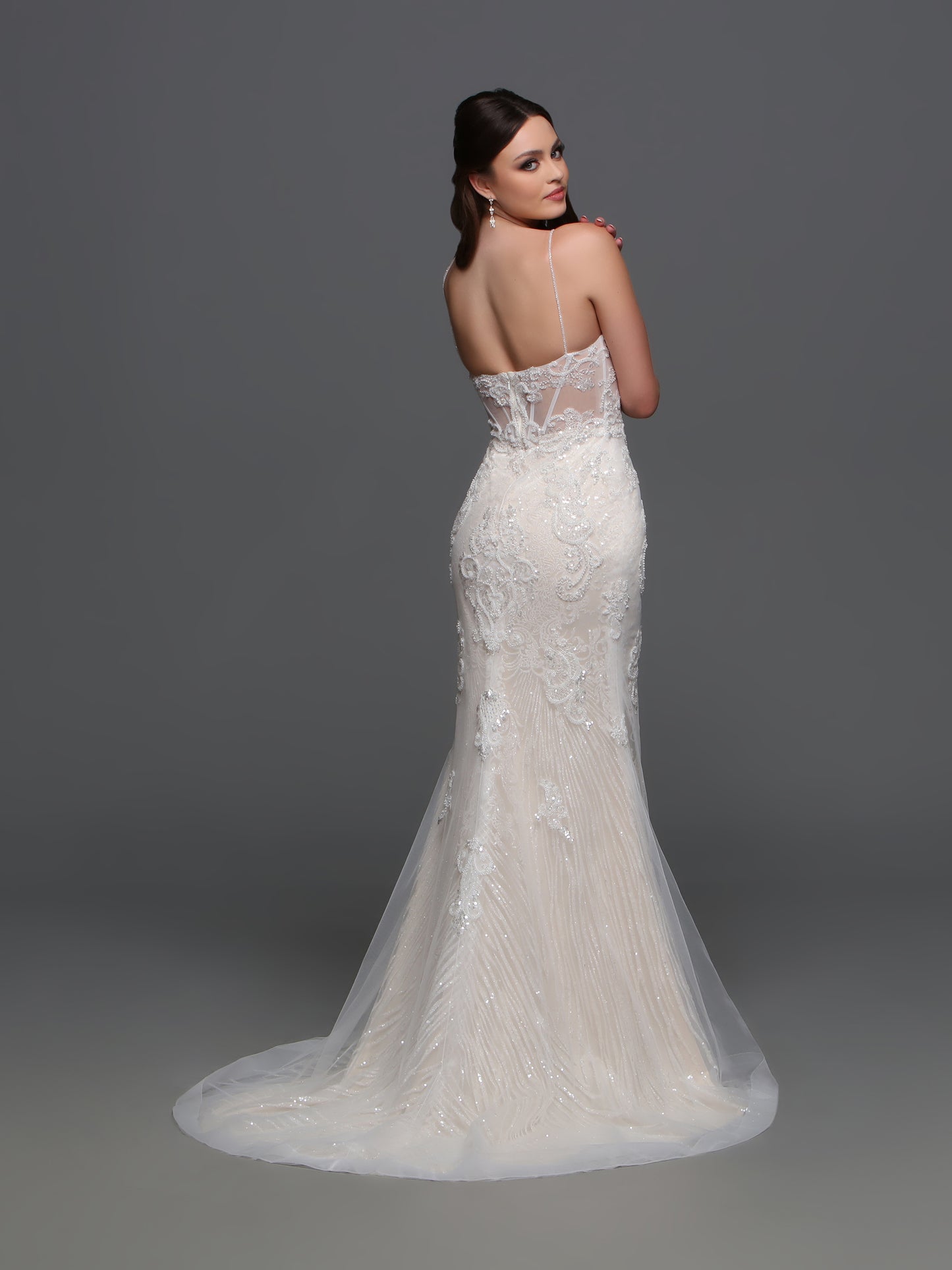 Elevate your wedding day look with the F123 Long Beaded Sheer Wedding Dress by Davinci Bridal. Featuring a mermaid silhouette and shimmering beadwork, this gown exudes luxury and sophistication. The sheer detailing and V-neckline add an elegant touch, making you the center of attention on your special day. A lovely blend of visual textures, this wedding dress features a sheer beaded lace applique bodice and a linear-pattern tulle skirt with a sheer overskirt with lace that matches the bodice.