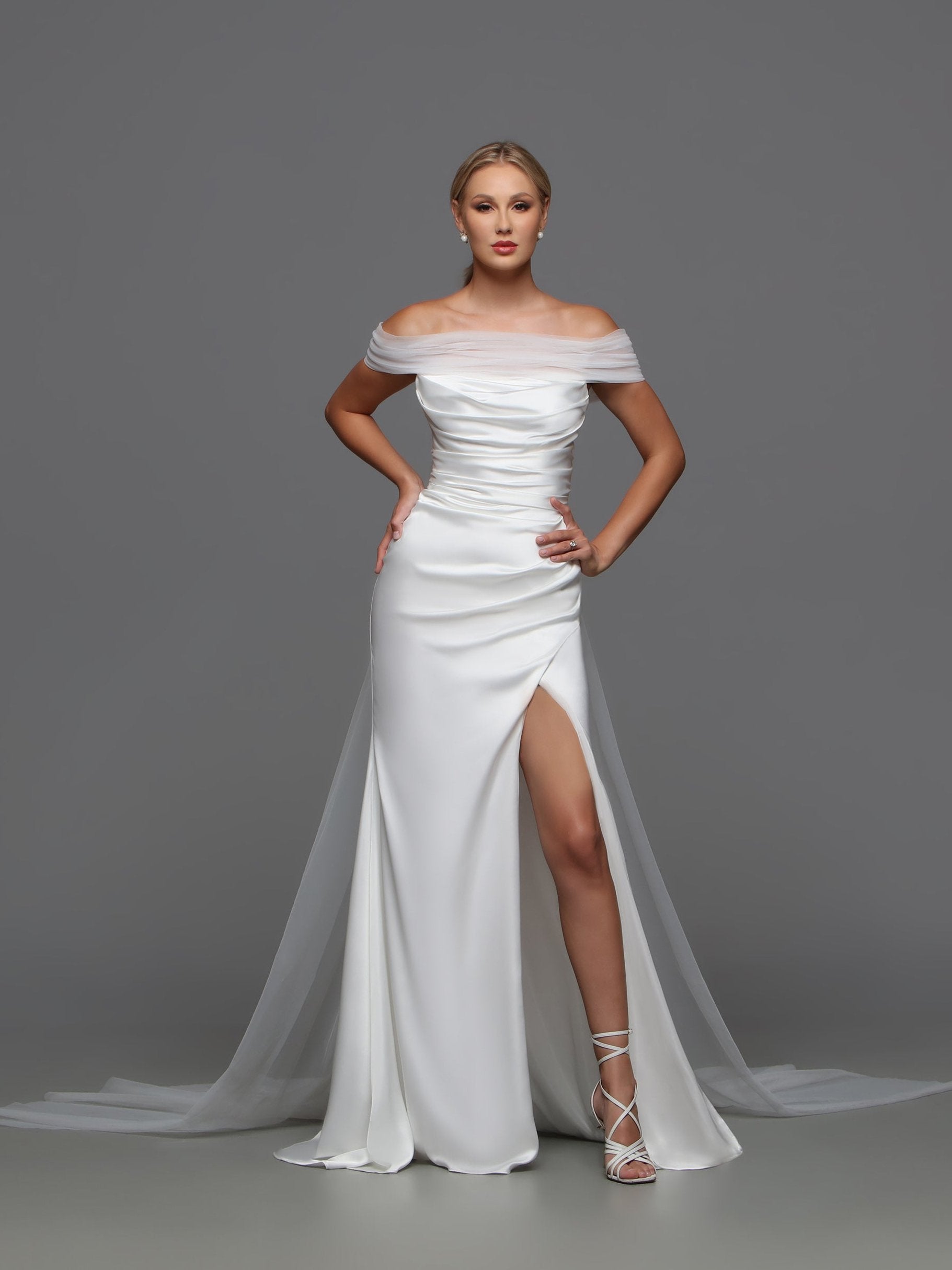 Elevate your wedding style with the Davinci F125 Fitted Satin Wedding Dress. The off the shoulder cape and slit strapless design exude sophistication and luxury. Crafted from high-quality satin, this bridal gown will make you the center of attention. Make a stunning statement on your special day. 