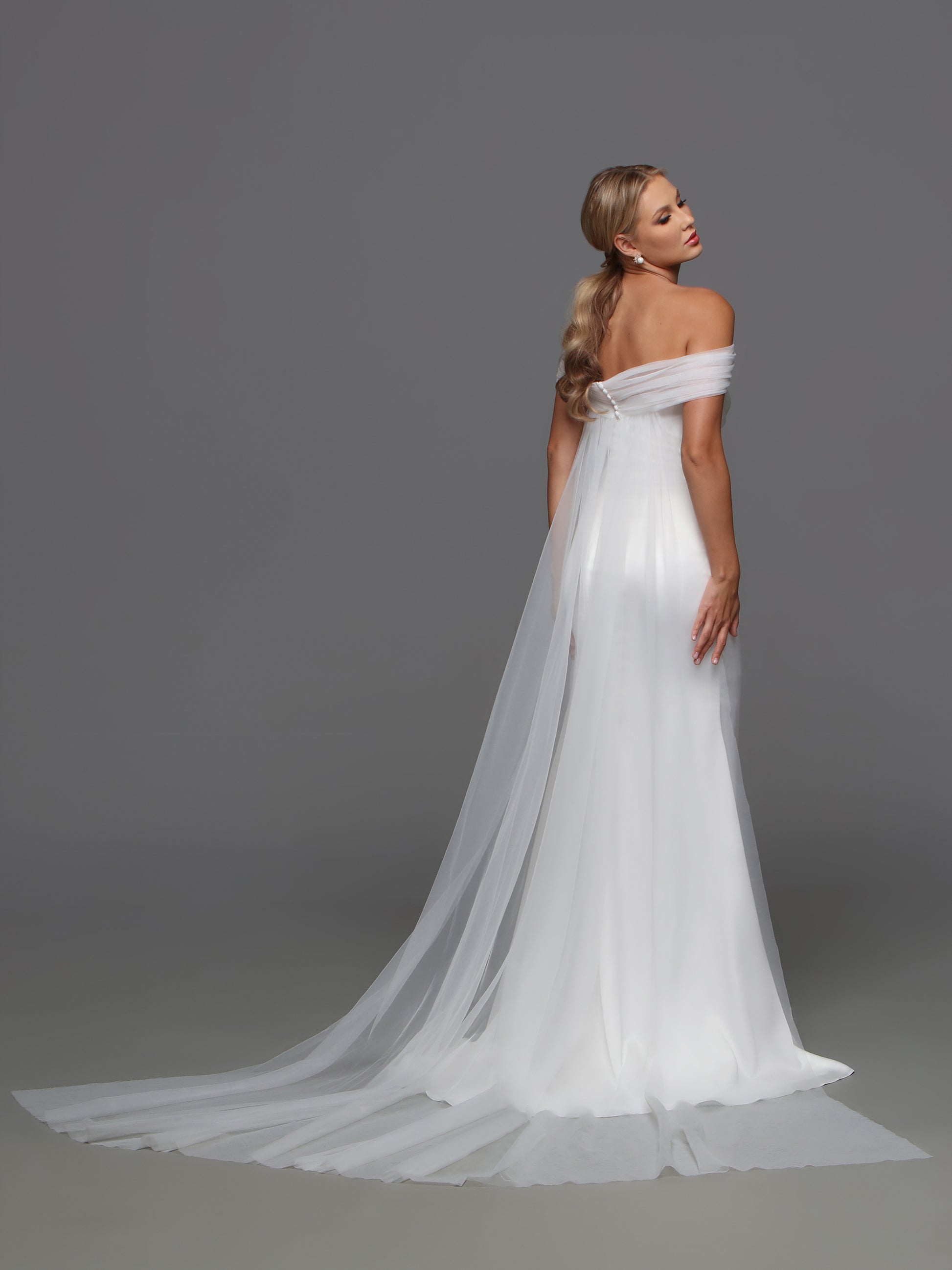 Elevate your wedding style with the Davinci F125 Fitted Satin Wedding Dress. The off the shoulder cape and slit strapless design exude sophistication and luxury. Crafted from high-quality satin, this bridal gown will make you the center of attention. Make a stunning statement on your special day. 