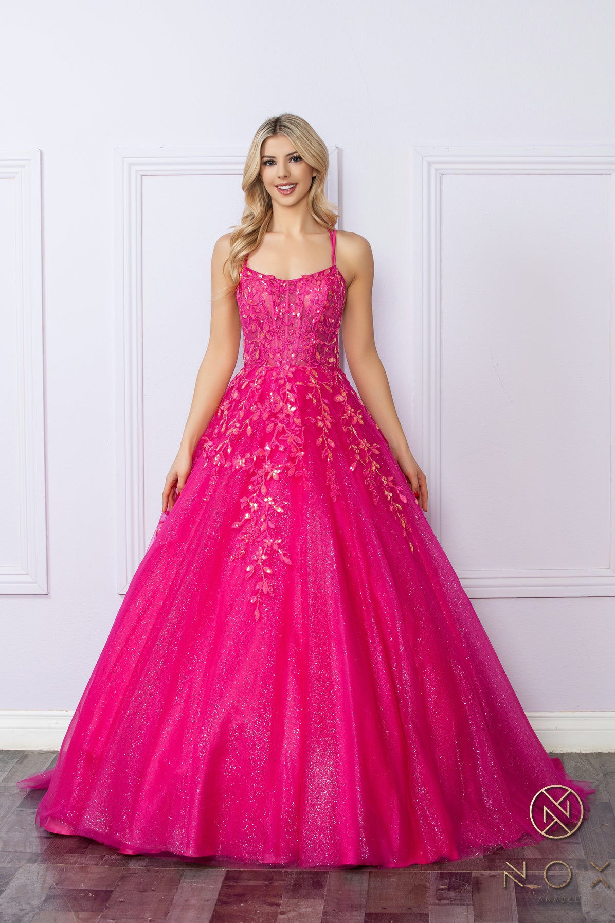 Elevate your prom night look with the Nox Anabel H1271 dress. This elegant A-line gown features a stunning shimmering tulle design with a sheer sequin corset and a flattering scoop neck. Perfect for making a statement with a touch of glamour.  Sizes: 00-16  Colors: Green, Fuchsia, Lavender