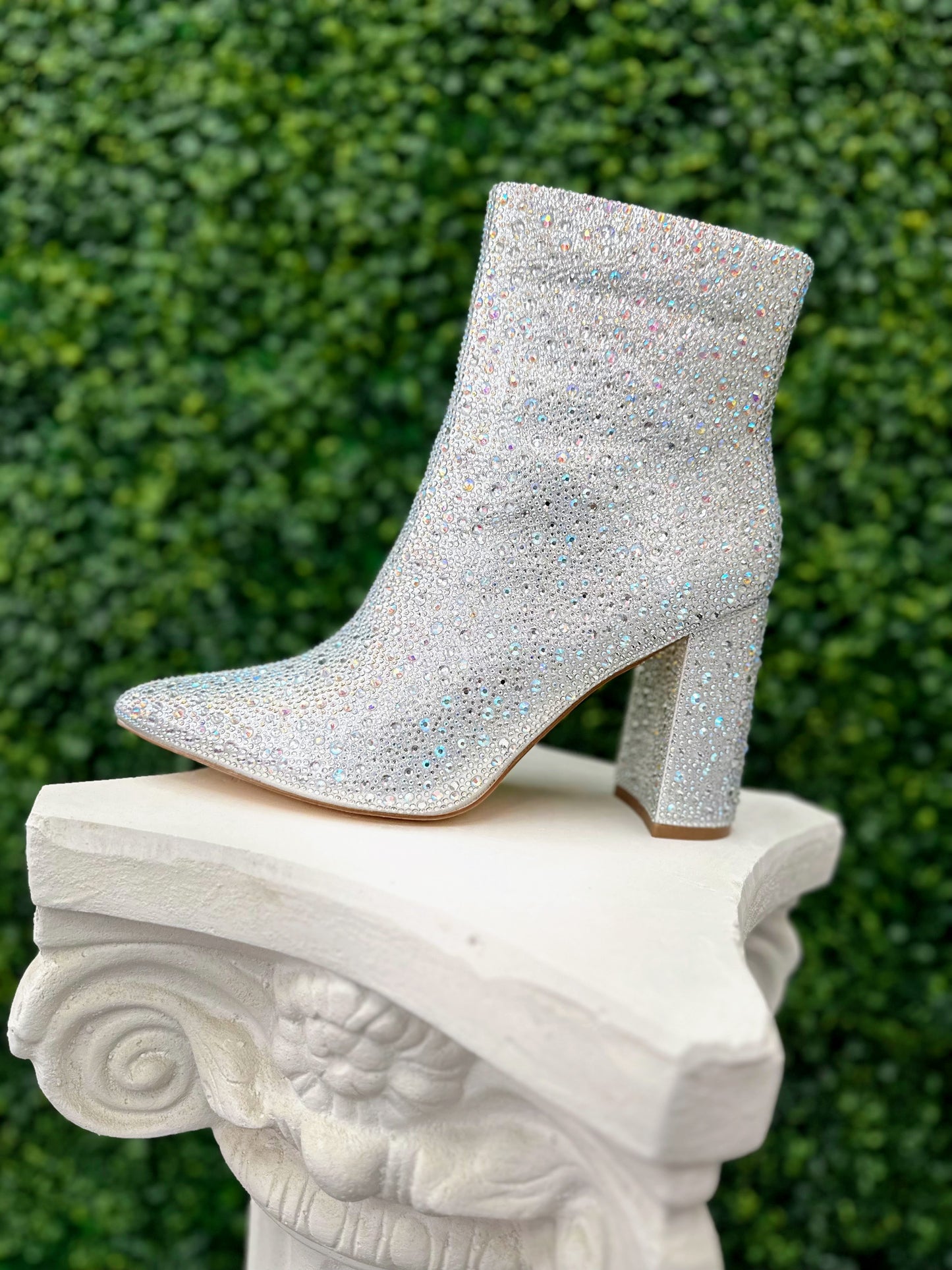 Expertly crafted to add a touch of elegance to any formal event, the De Blossom Melani Crystal Shimmer Formal Shoe is a must-have for any fashion enthusiast. Featuring a sleek block heel adorned with a variety of crystal sizes and a convenient zip up back, these ankle boots are perfect for proms, pageants, or any evening affair.