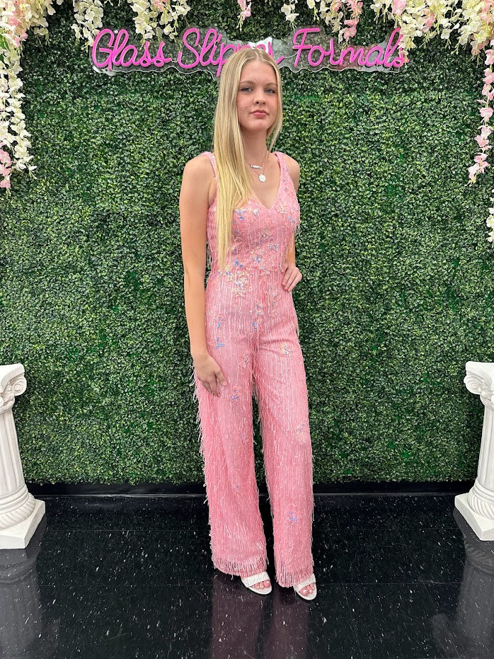 This Johnathan Kayne 31594 Jumpsuit is the perfect formalwear for special occasions. Crafted from shimmering sequin lace and delicately embellished with fringe, this size 4 pink jumpsuit is sure to turn heads.  * ONE OF A KIND  Size: 4  Color: Pink