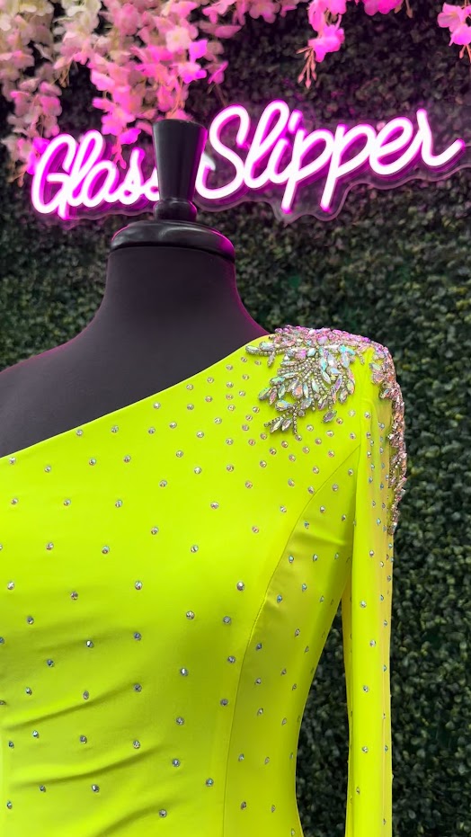 This Johnathan Kayne 2785 dress is perfect for your homecoming event. It features a single crystal shoulder, long sleeve with crystal wrist line, and stoned bodice for a sparkling look. It is also fitted for a flattering silhouette. Perfect for a memorable night.  Sizes: 4  Colors: Neon Green