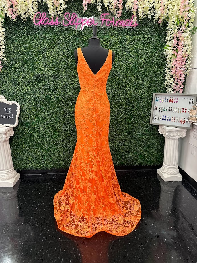 Look stunning in this Johnathan Kayne 31575 Size 4 Orange Lace V Neck Fitted Formal Prom Dress. Crafted from shimmering lace, this fitted design is sure to draw eyes. Show off your best features in this show-stopping dress.  Size: 4  Color: Orange