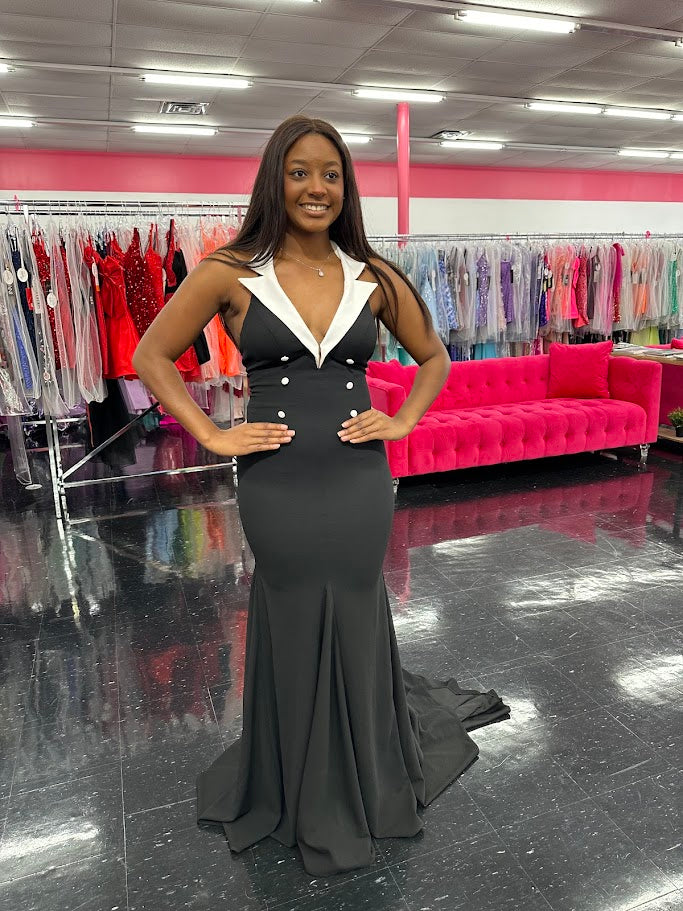 Elevate your evening attire with the Johnathan Kayne 1442 Size 4 Black Long Tuxedo Dress. This classy gown features a sleek tuxedo design, perfect for formal events or pageants. Its black color adds a touch of elegance, while the long length provides a sophisticated silhouette. Stand out from the crowd in style and confidence.