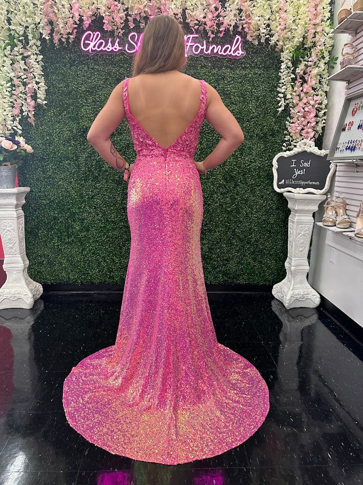 Expertly crafted by Jovani, the JVN36580 Prom Dress is a stunning masterpiece. With a sheer lace V-neck, sequin detailing, and a thigh-high slit, this formal evening gown exudes elegance and sophistication. Perfect for any formal occasion, this dress is sure to make a statement.  Sizes: 10  Colors: Hot Pink