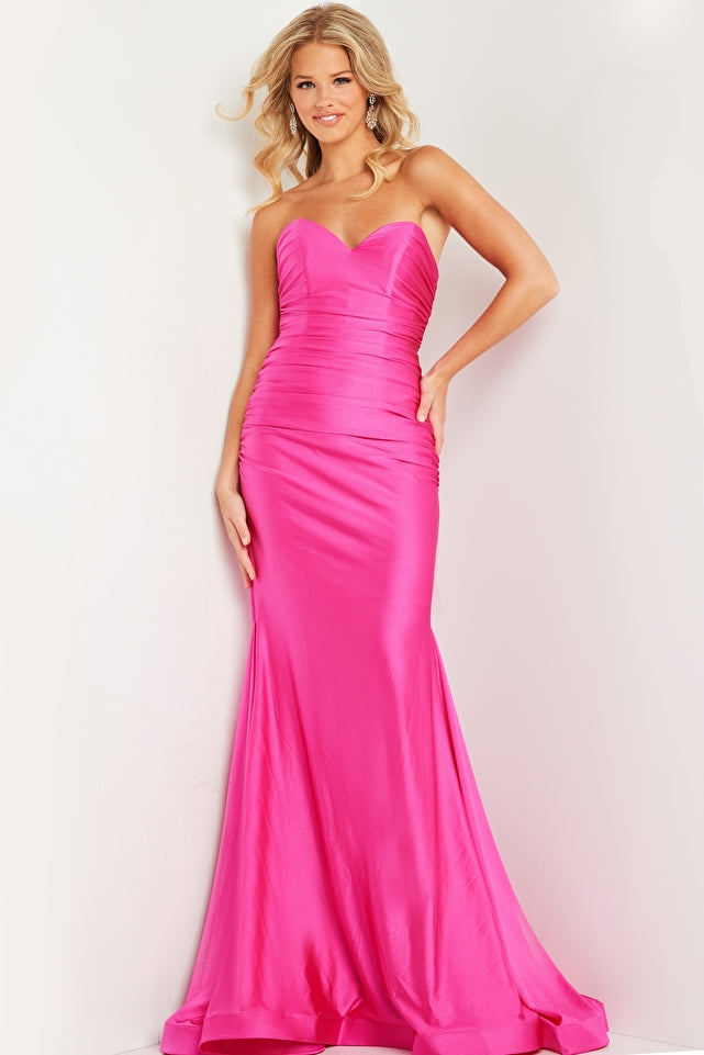 This stunning Jovani JVN37006 dress features a long ruched mermaid silhouette, perfect for any formal occasion. Made with high-quality jersey fabric, its strapless design exudes effortless elegance. Elevate your prom night or special event with this timeless and figure-flattering piece.  Sizes: 00-24  Colors: Black, Fuchsia