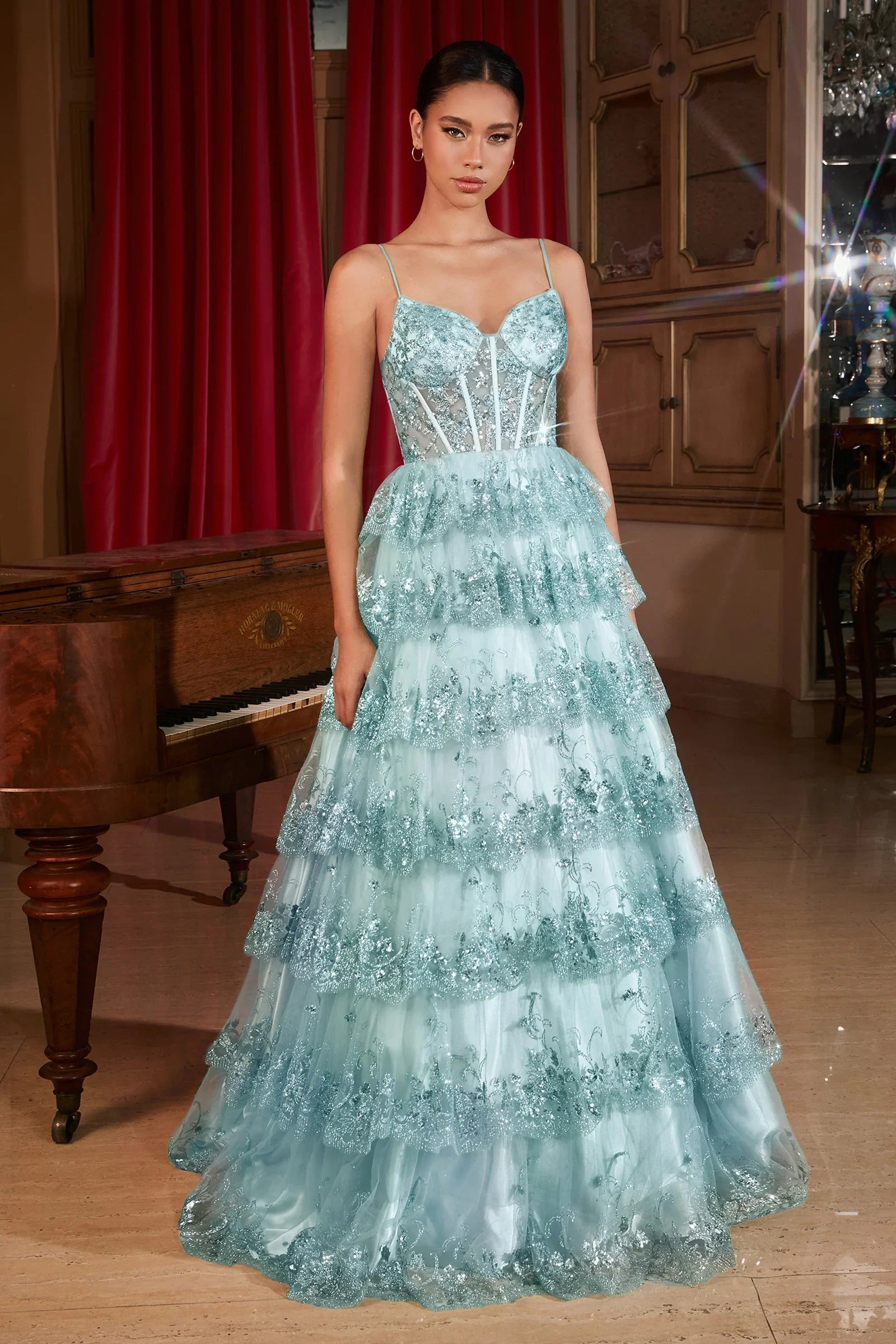 This Ladivine KV1108 Prom Dress features a sheer sequin corset, A-line cut, and ruffle detailing, creating a stunning and elegant silhouette. The layered tulle skirt adds volume and drama, making it the perfect option for formal events and balls. Step into enchantment with this sultry A-line ball gown—a bewitching fusion of glamour and allure. The layered tiered scalloped sequin ruffled skirt creates a mesmerizing play of light, ensuring every step is a symphony of elegance. 