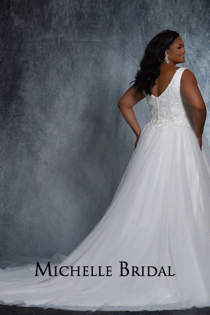 The Michelle Bridal For Sydney's Closet MB2109 Bridal Gown is a beautiful A-Line silhouette with layered tulle and sparkle tulle appliques, contemporary floral bridal lace, and a flattering V-Neck. Designed for plus size brides, this gown will make you feel like a true "Jewel" on your special day.