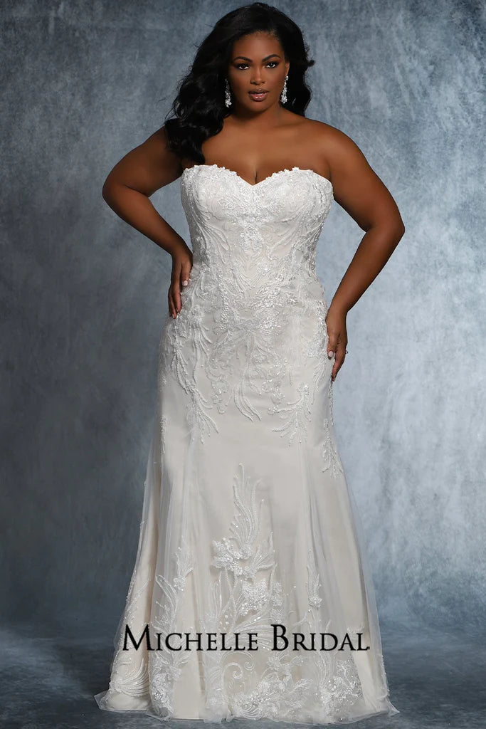 The Michelle Bridal for Sydney's Closet MB2117 is a stunning plus-size bridal gown featuring a strapless sweetheart neckline, lace-up back, and fitted silhouette adorned with floral appliques and pearls. Made with sequins for added sparkle, this striking gown will be sure to make any bride's special daydream come true.