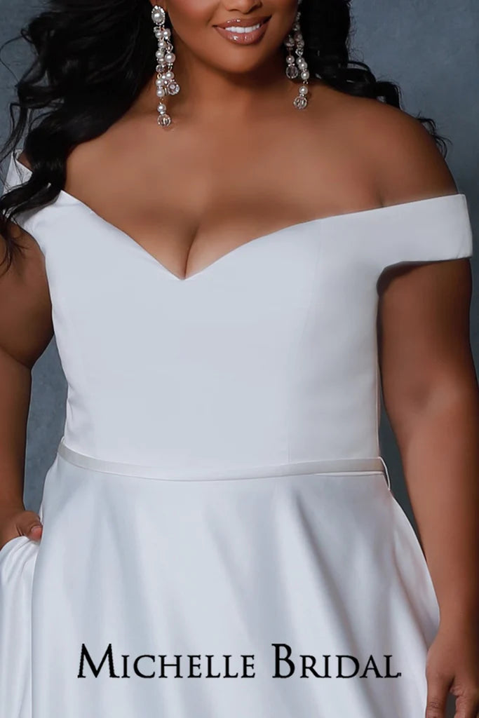 Michelle Bridal For Sydney's Closet MB2217 A-line Silhouette Off-The-Shoulder Straps Optional Satin Belt Pockets Thick Bridal Satin Plus Size "Bella" Bridal Gown. The Michelle Bridal For Sydney's Closet MB2217 bridal gown features an A-line silhouette and optional off-the-shoulder straps for extra style. Crafted with thick bridal satin and pockets, the gown also includes an optional satin belt to customize the look. Plus size available.