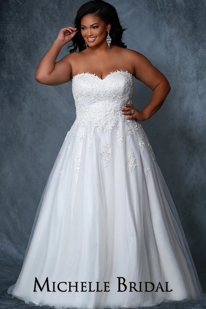 Michelle Bridal For Sydney's Closet MB2219 A-Line Silhouette Strapless Optional Straps Covered In Lace To Match Bodice Sweetheart Neckline Beaded Center Front Bodice Lace Up Back Plus Size "Yvonne" Bridal Gown. Walk down the aisle in this stunning plus size "Yvonne" bridal gown from Michelle Bridal for Sydney's Closet. It features an A-line silhouette with a beaded center front bodice, optional straps covered in lace to match the bodice, a sweetheart neckline, and a lace up back.