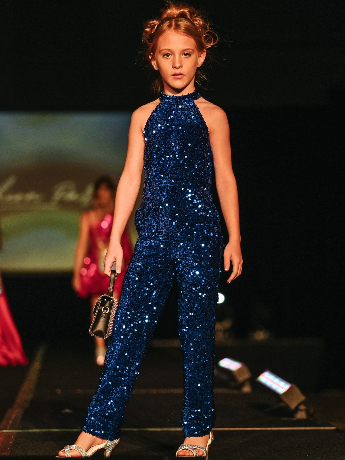 Marc-Defang-5022-Royal-Blue-Girls-Jumpsuit-sequins-high-neckline-velvetMarc Defang 5022 Long Girls Sequin Pageant Jumpsuit Fun Fashion High Neck  Very sparkle Iridescent colors  Fully beaded Halter Neck Back Straps  Side Pockets Knitted inner comfort lining Available Size: 4-14  Available Color: Royal Blue, Red, White, Light Pink, Light Blue