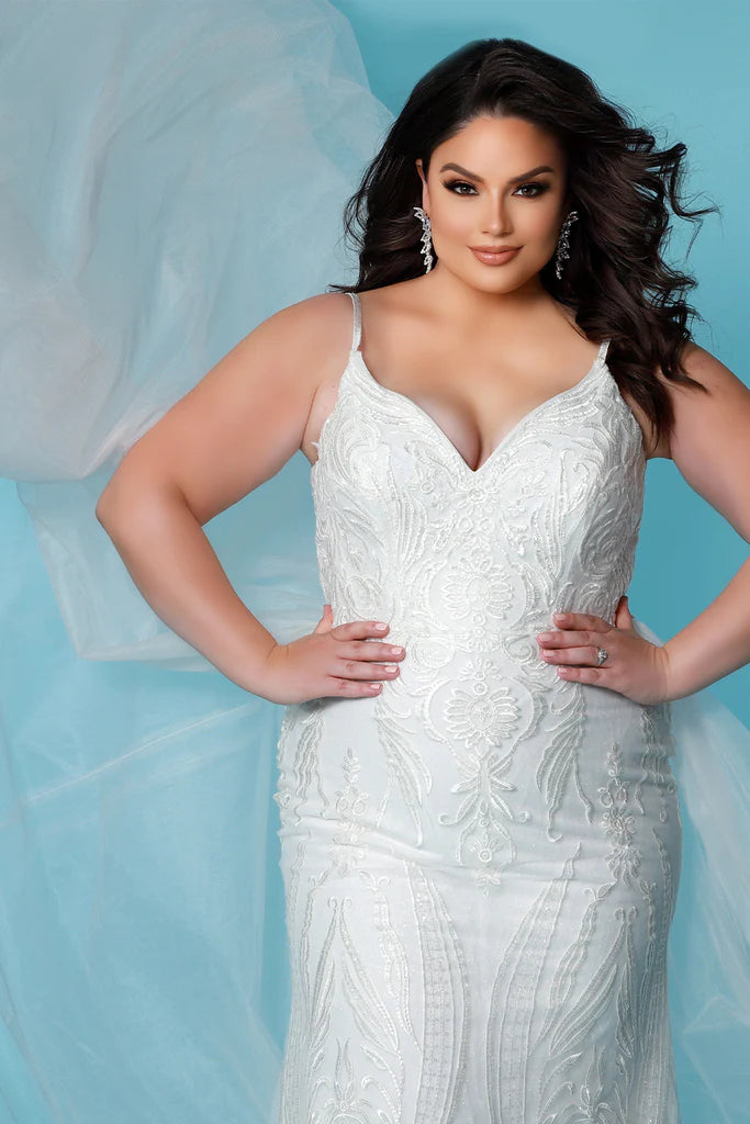 Sydneys Coset SC5287 Jolene Plus Size Bridal Dress. The Sydneys Coset SC5287 Jolene Plus Size Bridal Dress features an opulent, intricate bodice and cascading layers of matte chiffon on the skirt. Its timeless silhouette is cut to flatter the female form, and create an elegant statement as you take your place at the altar. This exquisite dress is designed exclusively for the plus size bride and is sure to make a lasting impression on your special day.