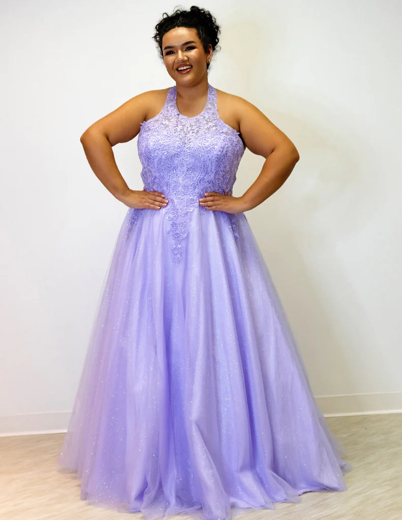 Sydney's Closet SC7352 A-Line Glitter Tulle Lace Appliques Lace Up Back Halter Neckline Plus Size Prom Dress. The Sydney's Closet SC7352 A-Line Glitter Tulle Lace Appliques Plus Size Prom Dress makes a glamorous addition to your wardrobe. This chic dress features an A-line silhouette, glitter tulle overlay, and delicate lace appliques - all crafted with an adjustable lace-up back and halter neckline. An elegant choice for formal occasions.