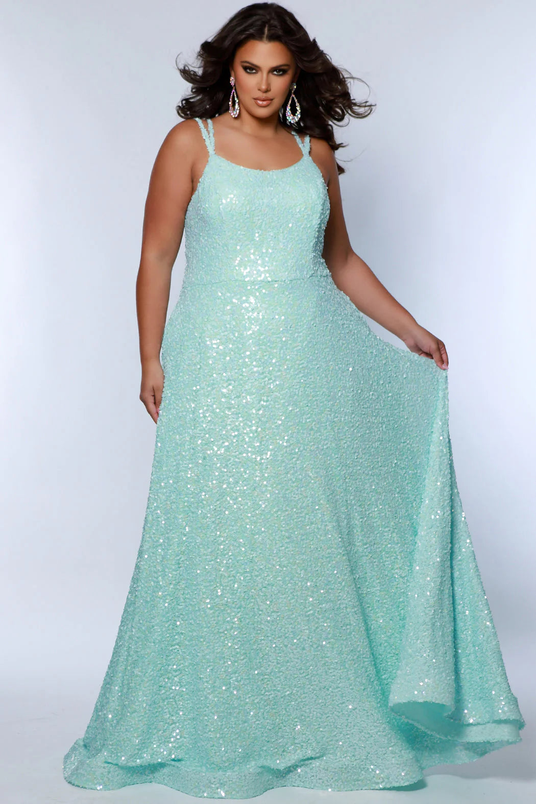 Be the belle of the ball in Sydneys Closet SC7365 Long Prom Dress. This plus size formal dress features an all-over sequin bodice with a scoop neckline, and a gathered A-line skirt with pockets. Perfect for prom nights, the elegant style of this gown will make you feel like a star.