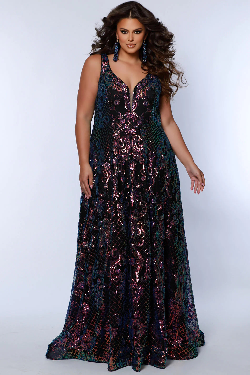 This elegant, plus size Sydneys Closet SC7367 Long Prom Dress features a V-neckline, sequins, pockets, and a long train--all crafted from a luxurious fabric for a stylish and comfortable look. Its timeless design makes it perfect for formal occasions. Make a trendy fashion statement at Prom or any formal when you wear this eye-catching plus size evening dress. 