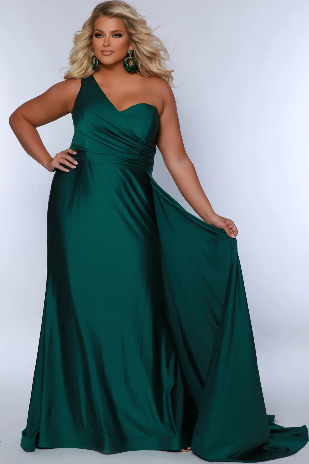 Experience elegance and glamour in the SC7377 gown from Sydneys Closet. This A-line over skirt dress features a one shoulder strap, perfect for your next special event or formal occasion. The full train adds a beautiful and regal finish to the look. Plus size available for up to size 24. Get ready to be the woman who turns heads at Prom 2024 or any special occasion evening event in the Simple and Sophisticated formal dress designed by Sydney's Closet.