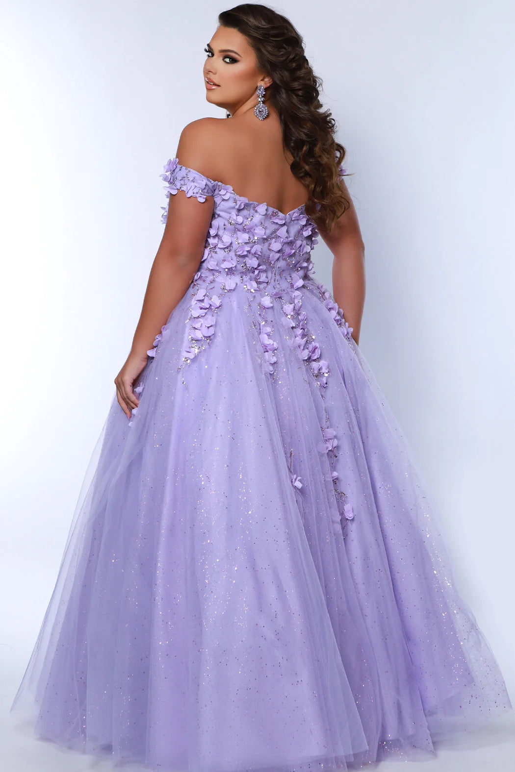 This glamorous Sydneys Closets SC7379 prom dress features an off-shoulder, sweetheart neckline and a fitted silhouette adorned with 3D floral details. The elegant design is perfect for a formal occasion such as a prom, pageant, or wedding. Plus size options are available for an ideal fit. Look and feel  like royalty at Prom 2024 or any formal ball when you opt to be lady who wears our "Dream On" gown.