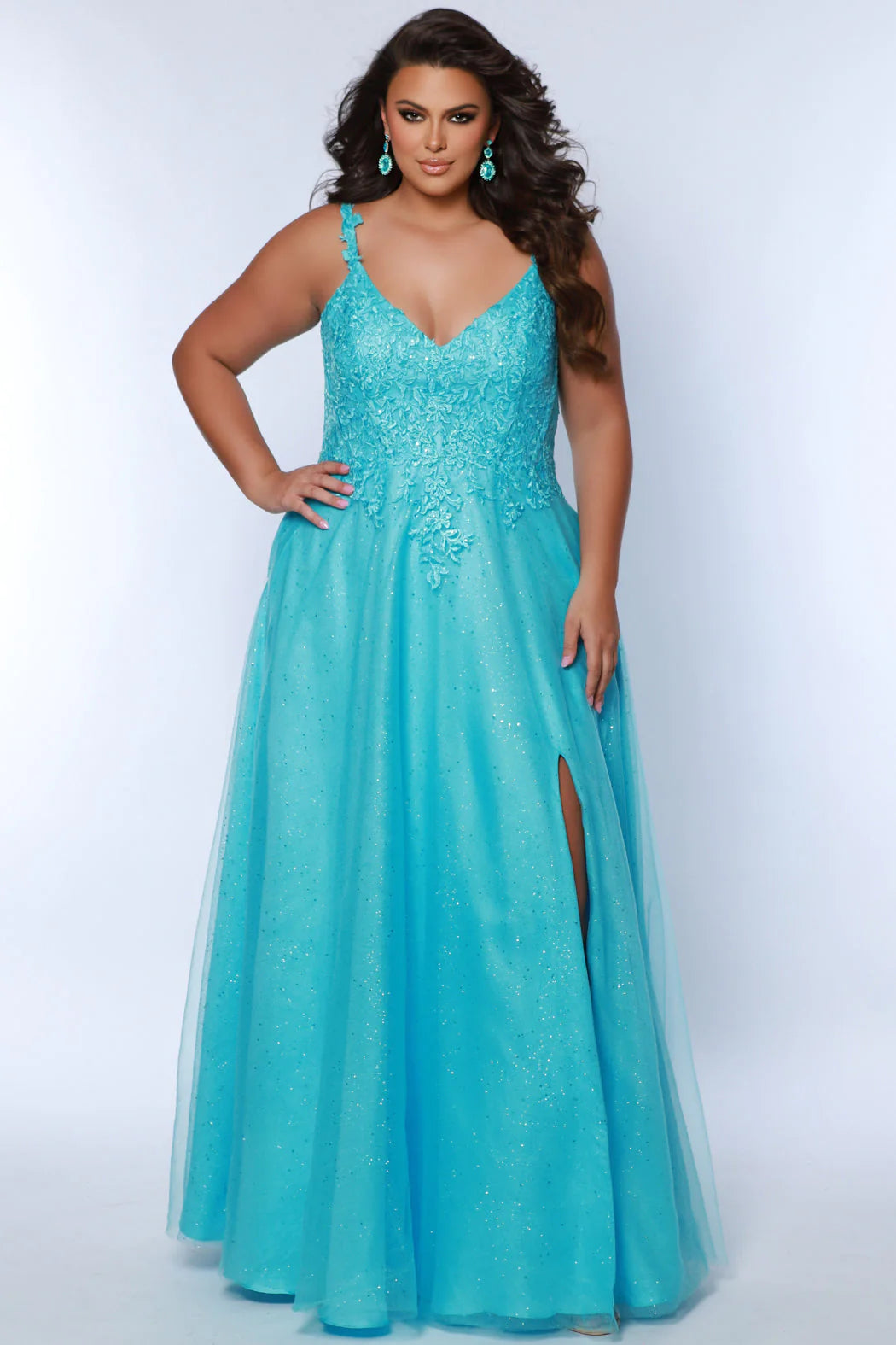 Look stunning at any formal event in a Sydneys Closet SC7384 Long Prom Dress. This A-line prom gown features a V-neckline with a scoop back, slit, pockets and a floor-length skirt complete the look. Ideal for plus size formal occasions. Pump up the fun factor at Prom 2024 when you arrive wearing this sparkly Aline evening dress. 