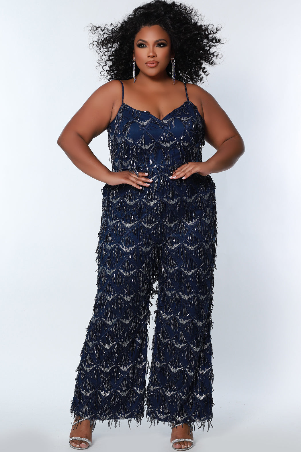 Sydney's Closet SC9108 Long Plus Size Sequin Fringe Jumpsuit Formal Pockets V Neck  Color: Diamond White, Navy, Sangria Size: 14-28 Sequin fringe Jumpsuit Spaghetti straps covered in sequins V-neckline Pockets Natural waistline Wide leg pant