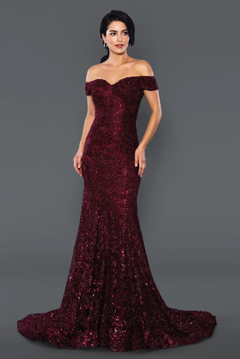 Stella Couture 22069 shimmer Glitter dress offers a stunningly glamorous look for prom. The fitted silhouette and off-the-shoulder design create an elegant, flattering shape, while sparkling glitter fabric adds a touch of glamour. Perfect for making a statement at your prom or special event. 