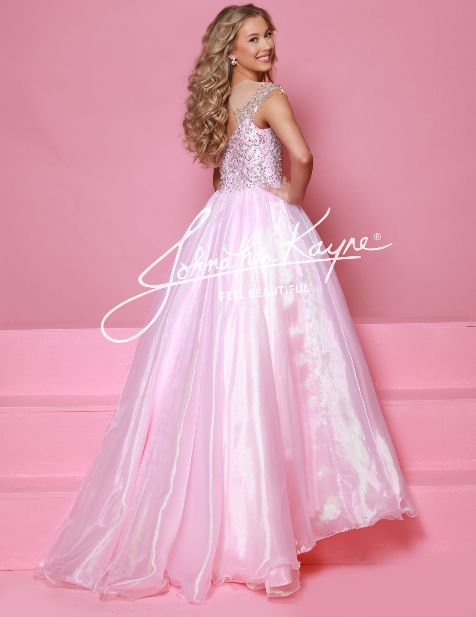  This Sugar Kayne C357 Girls Pageant Dress is a stunning ballgown that will make your little girl stand out on stage. The off the shoulder design and fringe detailing add a touch of glamour, while the shimmer fabric gives the dress a beautiful shine. Perfect for formal events and pageants.