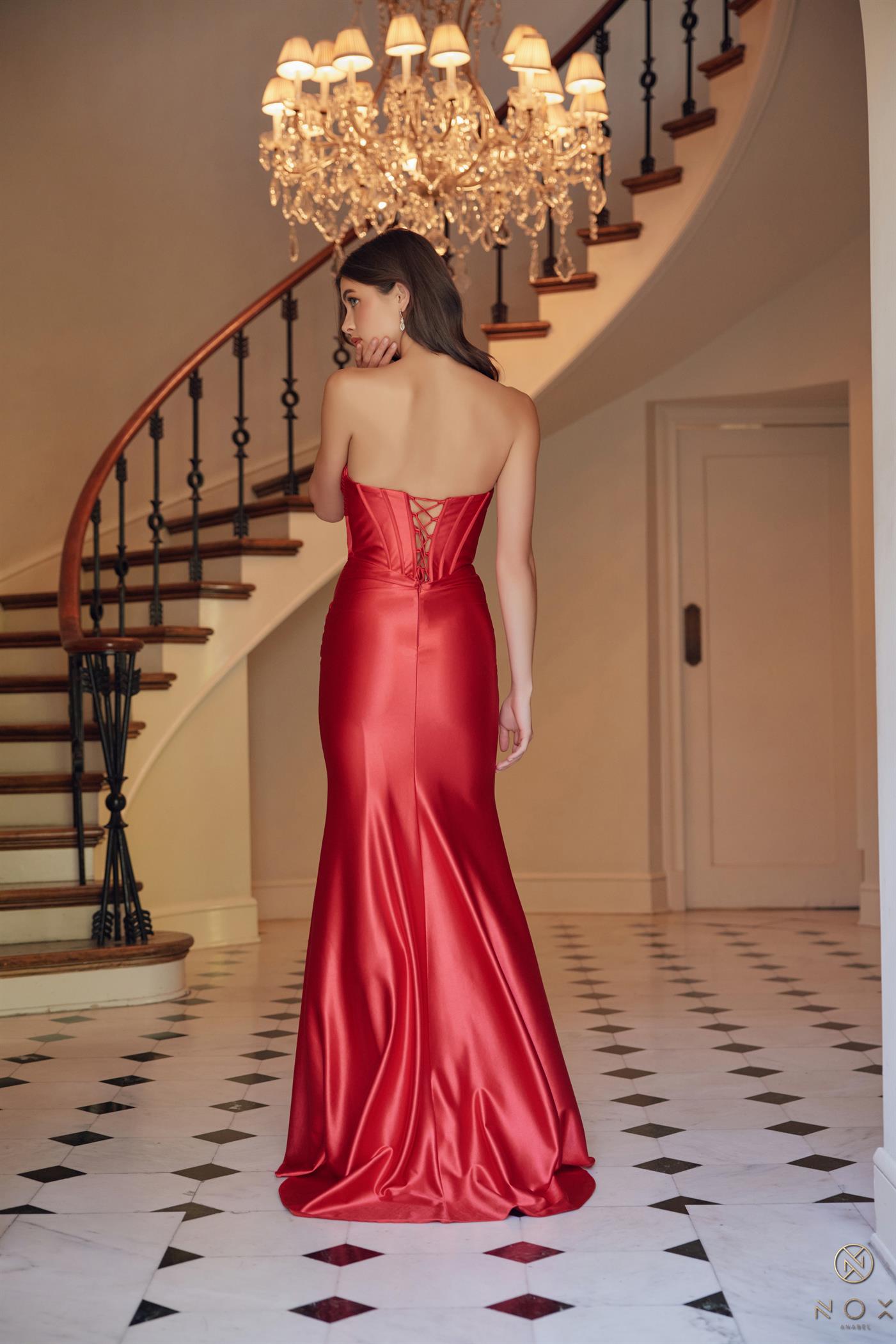 Shine bright at prom in the Nox Anabel T1500 Long Formal Corset Dress. With a cut out bodice and strapless sweetheart neckline, this gown is perfect for a fun and flirty evening. The corset bodice and ruched detailing add a touch of elegance, making you the star of the night.