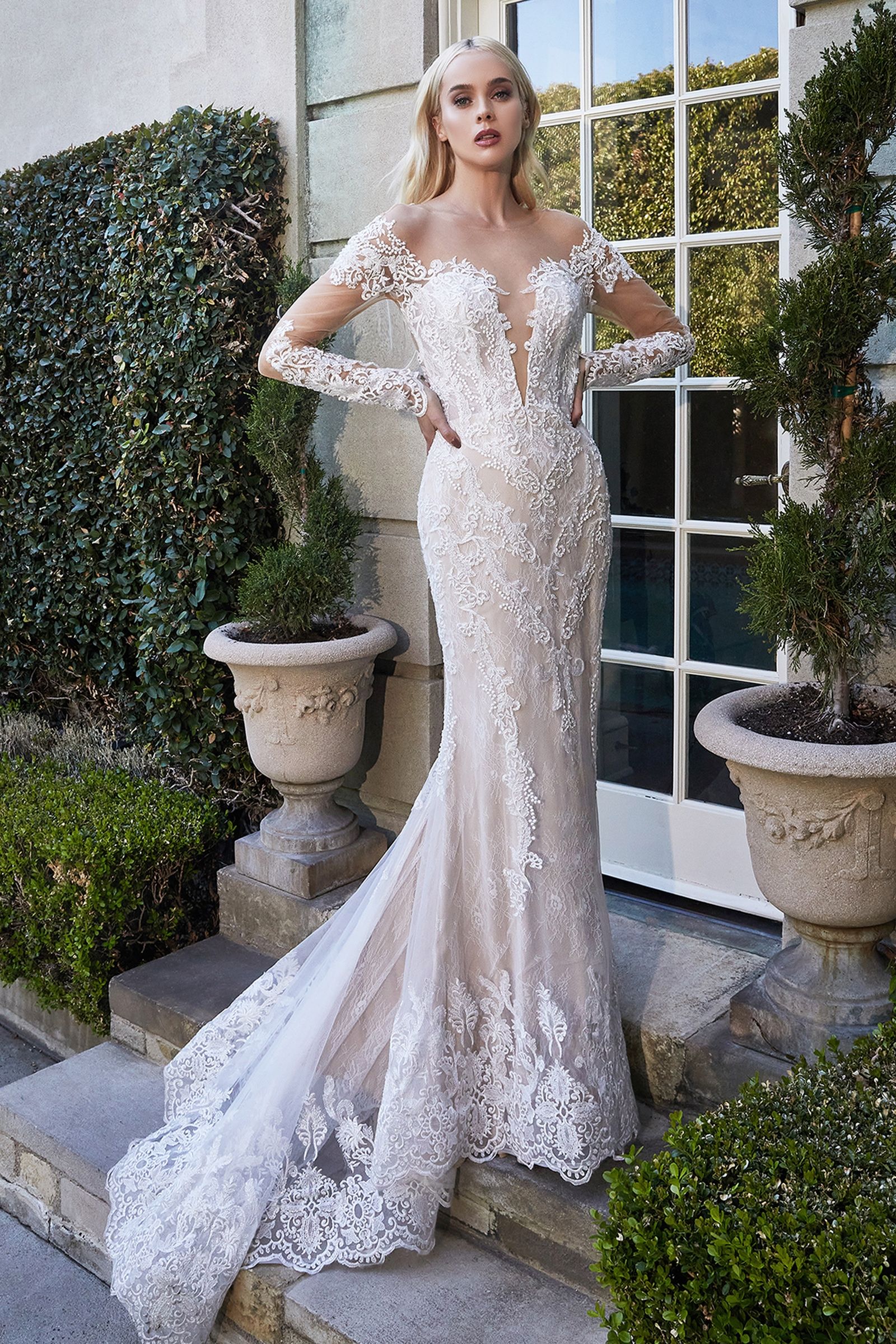 This gorgeous long sleeve lace wedding gown showcases beautiful lace work through out the body. Classic from front and sexy from back with a heart-shaped opening, this gown truly is designed to make a bride feel beautiful. The lace at sleeve grazes the knuckle for the ultimate ring-closeup shot. Luxurious lace scalloped hem is elongated at back to creates a breathtaking mermaid silhouette.