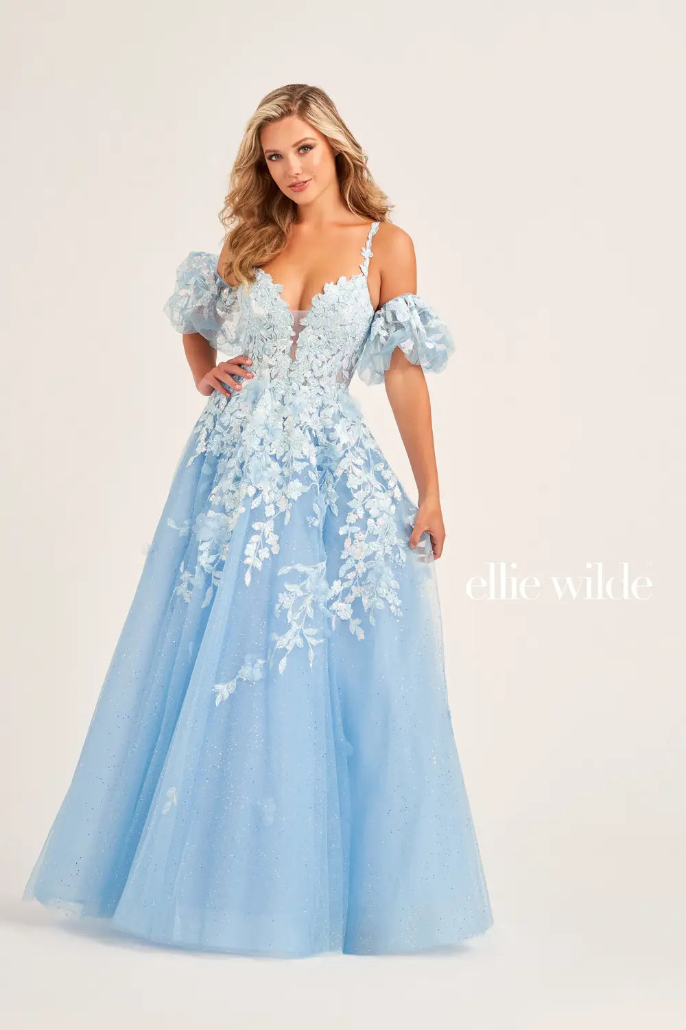 The Ellie Wilde EW35205 Prom Dress combines sheer sequin lace with a corset top and A-line silhouette, creating a stunning and shimmering gown. The puff sleeves add a touch of glamour, making this dress perfect for any prom or formal event. Pockets  Sizes: 00-20  Colors: Sage, Ice Blue