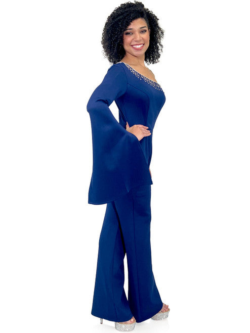 Enhance your evening look with Marc Defang's 8267 Pageant Jumpsuit. This elegant design features a one-shoulder neckline, One long bell sleeves, a crystal fringe detail and a fitted silhouette. Update your wardrobe with this fashionable and flattering piece.  Sizes: 00-16  Colors: Hot Pink, Royal Blue, Neon Green, Light Blue, Black  Contact us for custom colors - Allow 30 days Production