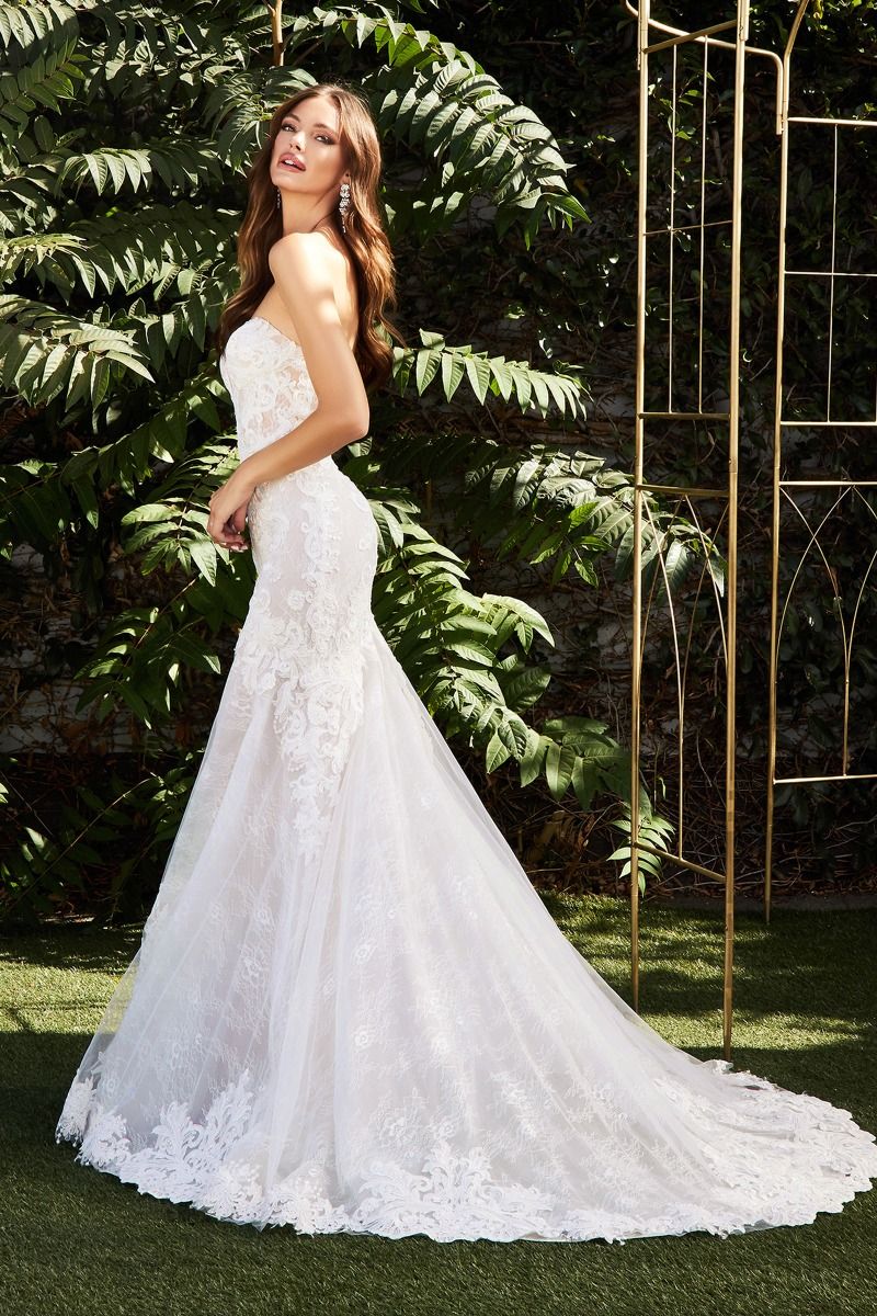 Look like a dream in the Ladivine CD928 long lace mermaid wedding dress. Featuring a stunning lacework that cinches the waist, corset bodice, and scallops at the hem, this gown creates an hourglass silhouette that is perfect for the special bride. The removable back tail allows for an elegant look during the ceremony and a more relaxed look for the reception. Make your wedding day extra special with the Ladivine CD928.