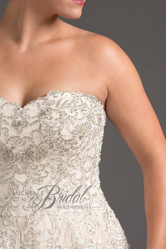 Michelle Bridal For Sydney's Closet MB1819 A-Line Sweetheart Neckline Strapless Lace Up Back Heavily Beaded Bodice Plus Size "Vanessa" Bridal Gown. Impress your guests on your special day with the luxurious Vanessa bridal gown from Michelle Bridal for Sydney's Closet. Crafted with a sweetheart neckline and a heavily beaded bodice, this strapless A-line gown also features a stylish lace-up back. Make a lasting impression in this plus size dress.