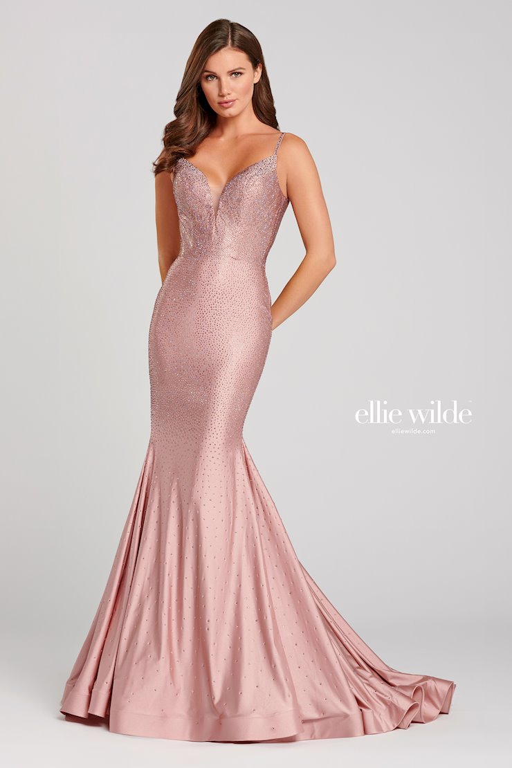 Look stunning in this Ellie Wilde EW120012 prom dress. This gorgeous mermaid-style gown has a backless crystal jersey design and sparkling crystal appliqué detailing that will make you shine on the dance floor. The fitted jersey fabric ensures that you’ll look your best in this dazzling gown. Sleeveless novelty stretch fit and flare gown with a plunging V-neck, natural waist, stone accents throughout gown, open bandeau back, horsehair hem and a sweep train.