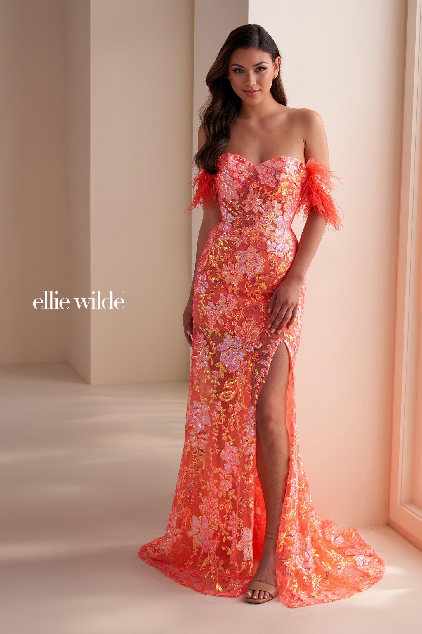 The Ellie Wilde EW34034 is a glamorous formal gown featuring an off-the-shoulder neckline, corset bodice, and a full-length sheer sequin skirt with a side slit. Festooned with a beautiful feather trim, this dress is sure to make a statement.

Sizes: 00-16

Colors:&nbsp;ORANGE, ROYAL BLUE, LILAC, HOT PINK, SAPPHIRE, SKY BLUE, EMERALD, PURPLE RAIN, Dusk, Lavender Dream, Black, Ivory, Coral