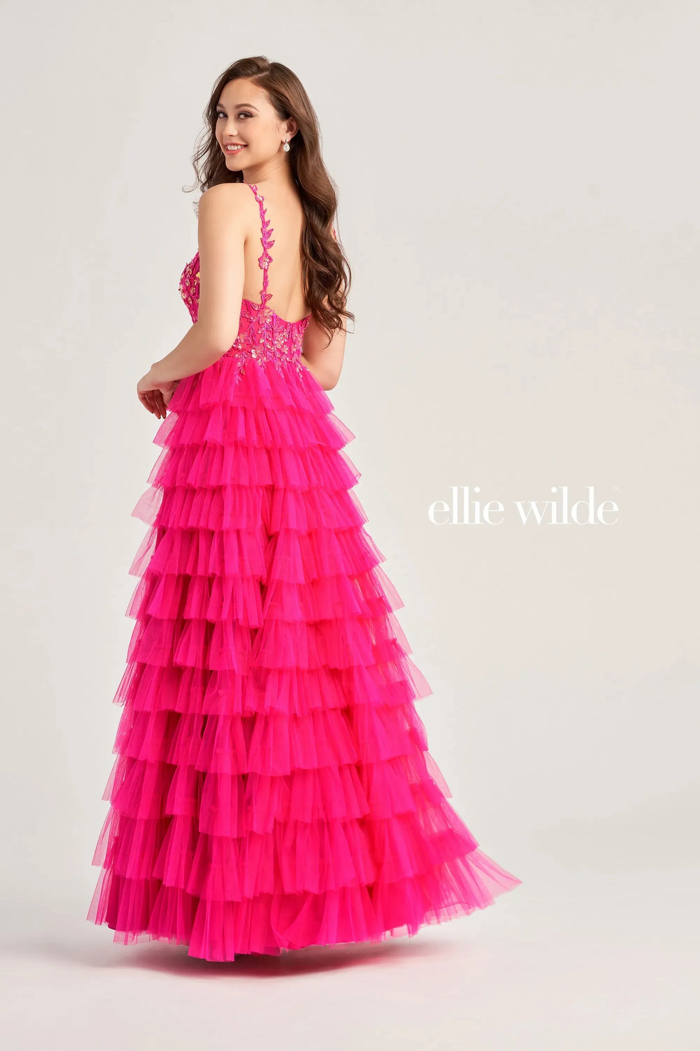 This Ellie Wilde EW35059 prom dress exudes elegance and glamour. The long tulle layers, A-line silhouette, and lace Sequin corset enhance your natural curves, while the maxi slit and sequin details add a touch of sparkle. Perfect for prom or any formal event, this dress is sure to make a statement.  Sizes: 00-20  Colors: ﻿BLACK, MAGENTA, ROYAL BLUE, BARBIE PINK