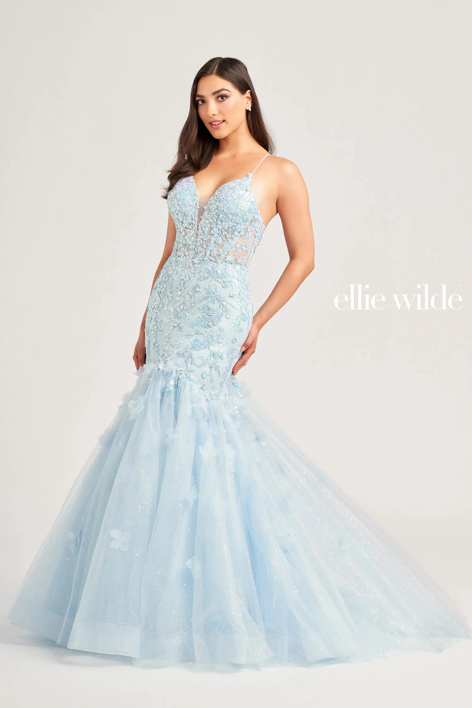 Expertly designed with a sheer lace corset and shimmering sequins, the Ellie Wilde EW35080 Prom Dress exudes elegance and sophistication. The mermaid silhouette accentuates curves, making you feel confident and glamorous. Perfect for prom or any formal occasion, this gown is sure to make a statement.  Sizes: 00-16  Colors: Light Blue, Hot Pink, Orange