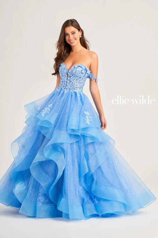 Make a statement in the Ellie Wilde EW35084 prom dress. Featuring an off-the-shoulder top, shimmer sequin lace and ruffle detail, the dress offers a timeless and sophisticated look perfect for the big night. Keep it classic in this classic formal gown.  Sizes: 00-24  Colors: EMERALD, ROYAL BLUE, TEAL, HOT PINK, BLUEBELL