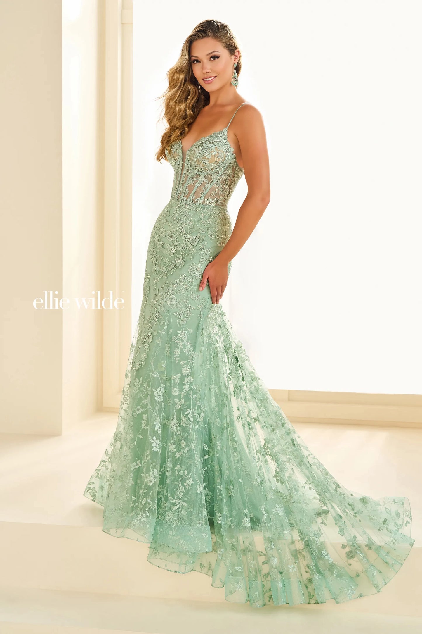 Expertly designed by Ellie Wilde, the EW36009 Long Sheer Lace Corset Prom Dress is the ultimate choice for any formal occasion. Featuring a stunning mermaid silhouette and delicate lace detailing, this gown is sure to turn heads. The corset bodice offers a flattering fit, making you feel confident and beautiful all night long. Perfect for prom, pageants, or any special event, this dress is a must-have for any fashion-forward individual.