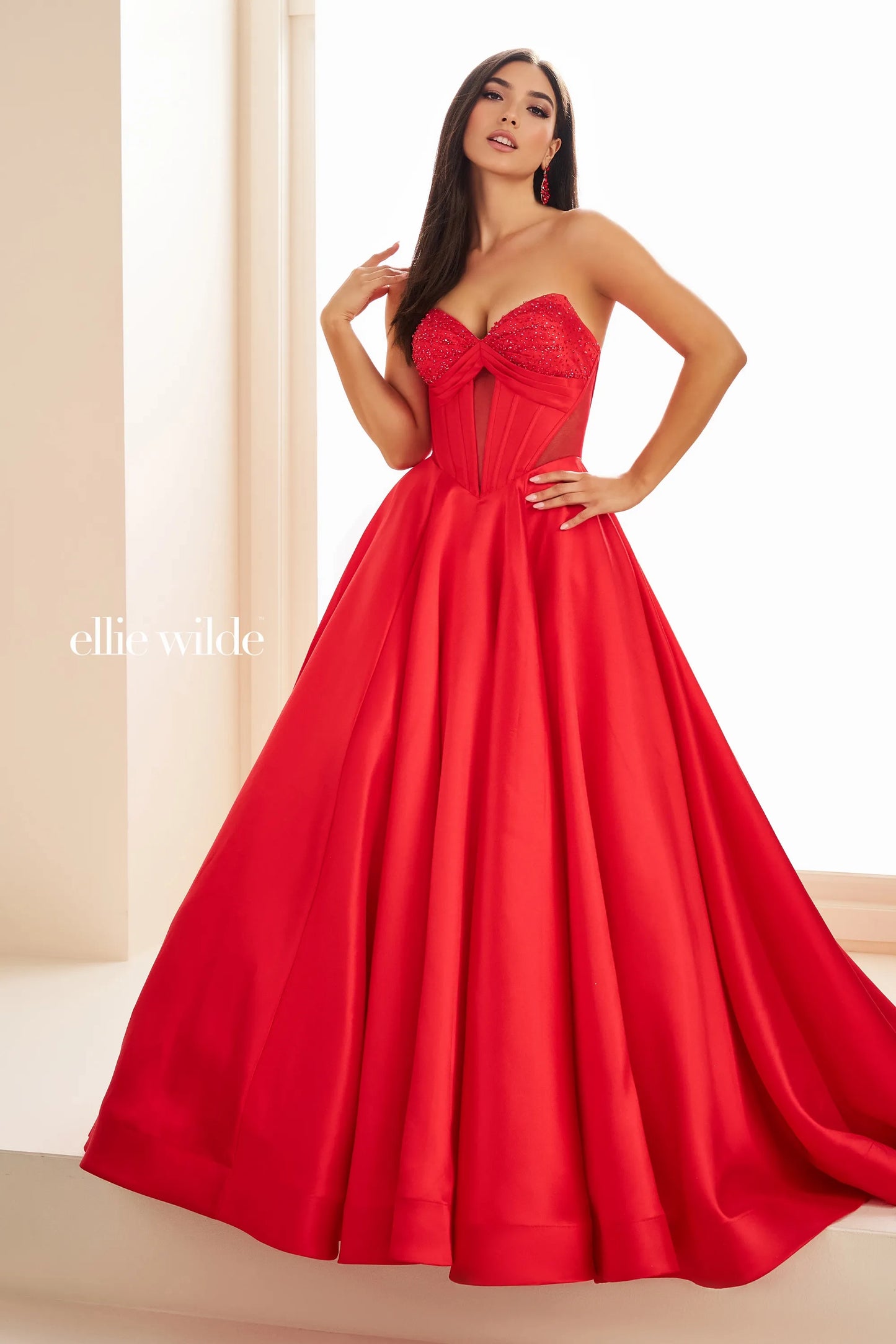 This Ellie Wilde EW36025 prom dress features a stunning A-line silhouette with sheer ballgown detailing and a corset back for a perfect fit. The dress also includes convenient pockets and cut-out design, making it both fashionable and functional for any pageant or formal event.