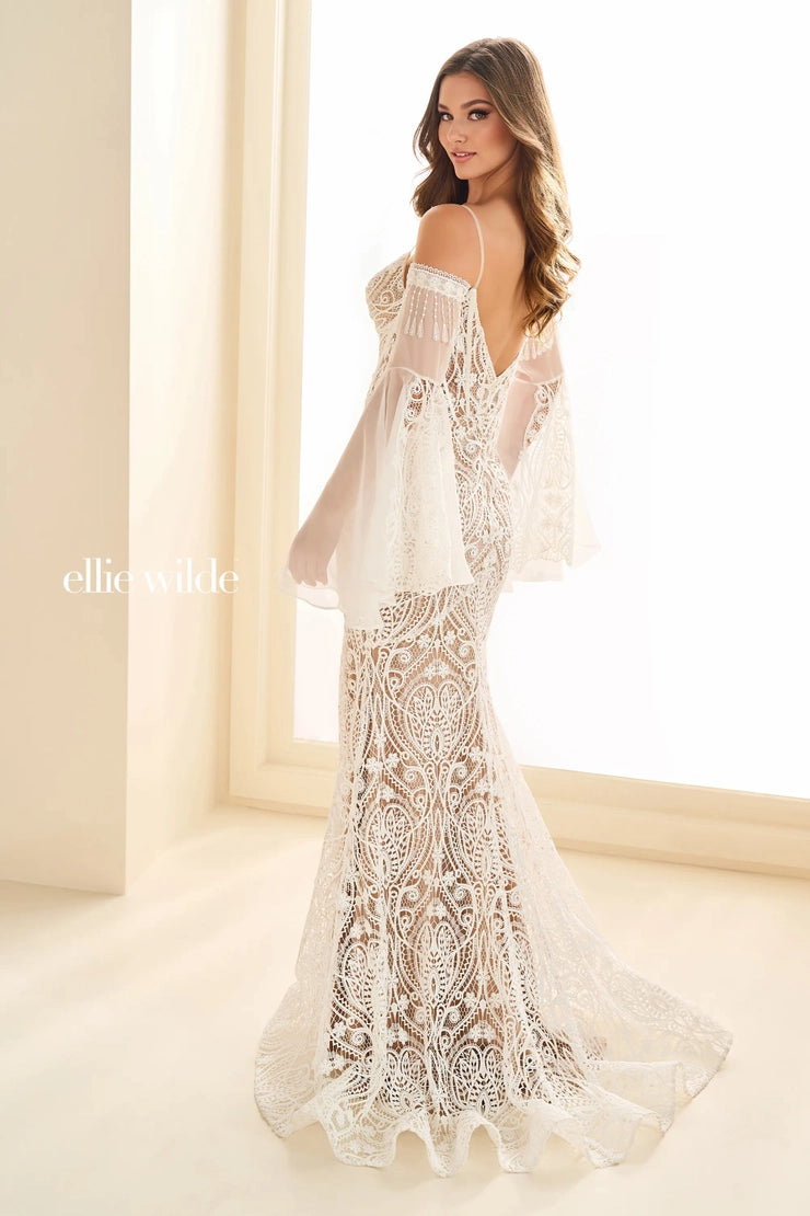 Discover the stunning beauty of the Ellie Wilde EW36030 dress. This boho-inspired mermaid gown features long bell sleeves and a sheer corset to enhance your natural curves. Perfect for bridal, evening, or reception events, this dress will make you stand out with its unique, modern design.&nbsp; Venise Lace. Back wedding dress - reception gown - bridal

Sizes: 00-24

Colors; Black/Nude, Ivory/Nude, Red, Royal Blue