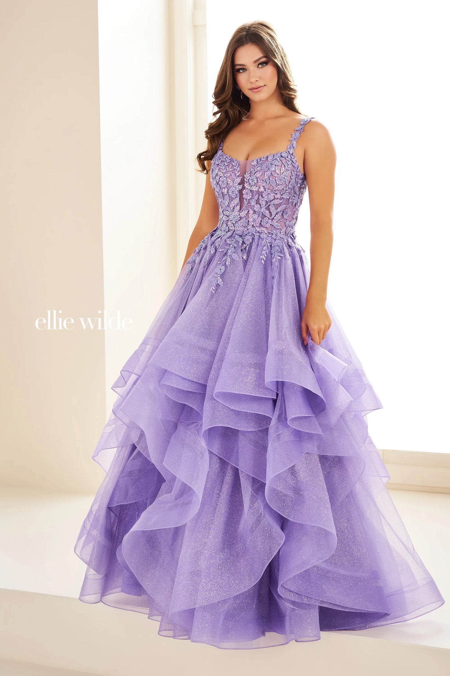 Expertly crafted by Ellie Wilde, the EW36035 dress boasts a sheer lace shimmer, ruffle details, and a corset-style bodice. Completed with a sequin layer for added sparkle, this ballgown will make you stand out at any prom or formal event. Elevate your style and confidence with this stunning dress.