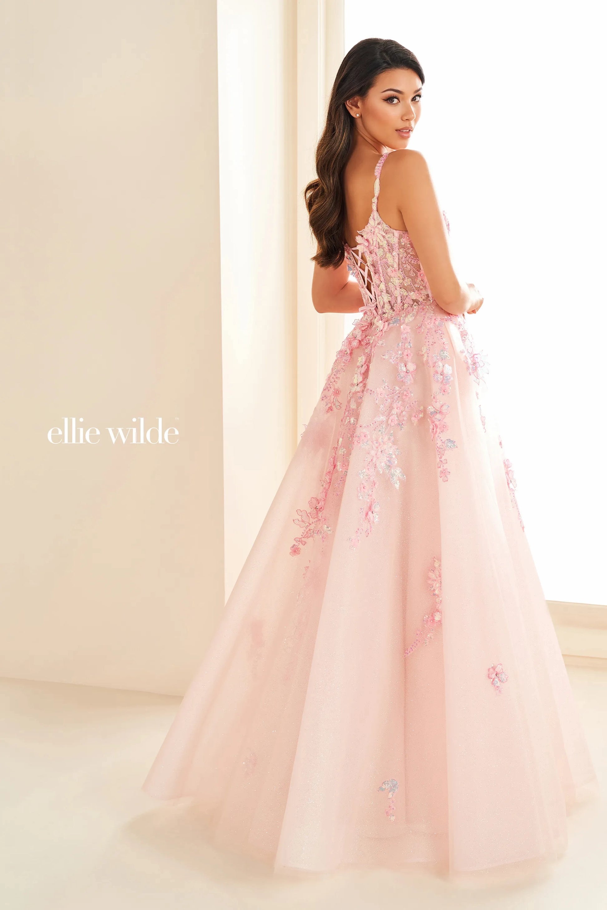 Elevate your style with the Ellie Wilde EW36213 dress. This stunning prom dress features a sheer lace corset top, Shimmer V-neckline, and A-line silhouette that will gracefully accentuate your curves. With this gown, you'll feel like a work of art, ready to make a statement at any formal event.