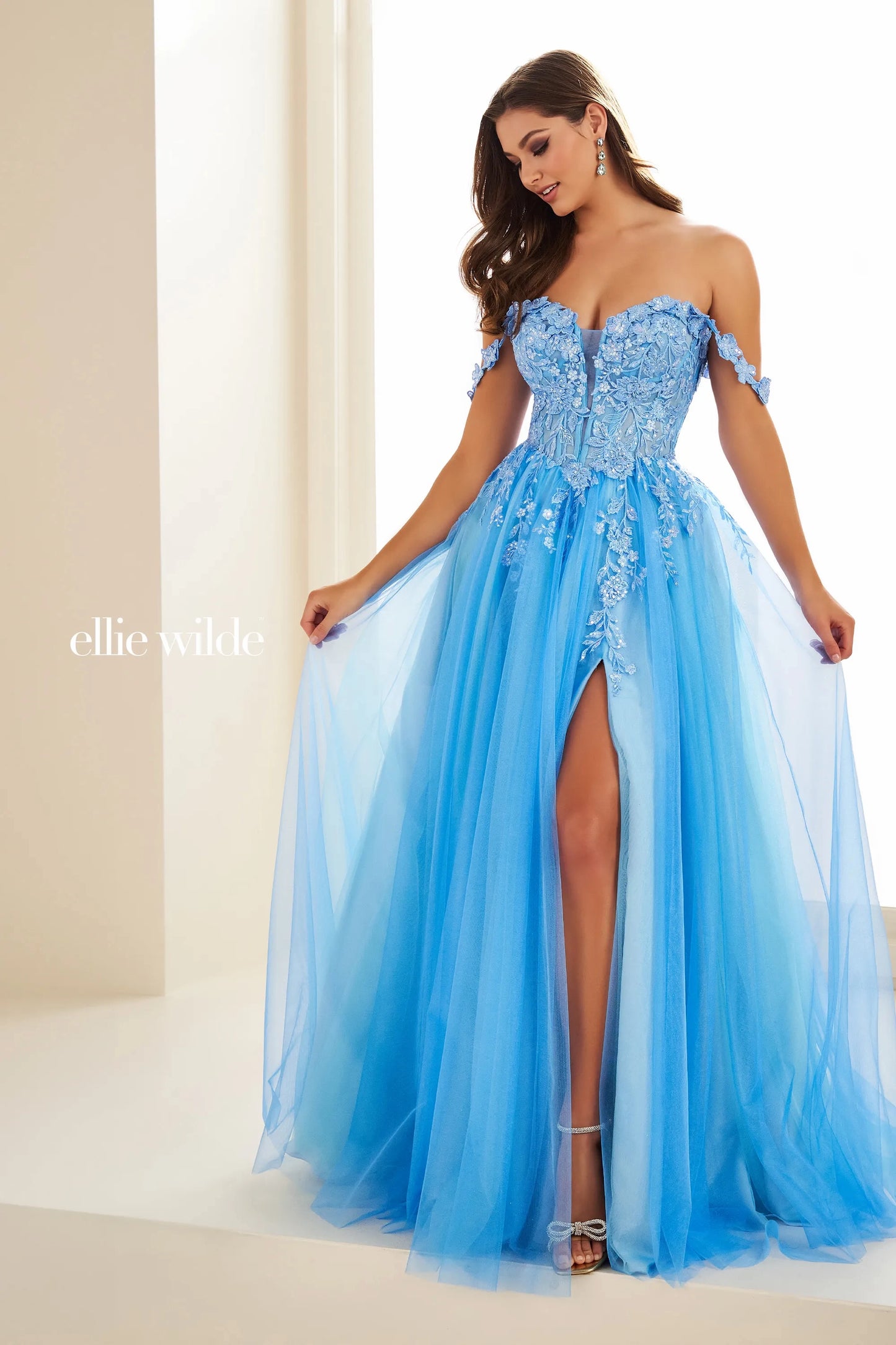 Indulge in luxury and elegance with the Ellie Wilde EW36214 Prom Dress. This long maxi gown boasts a sheer lace corset that cinches your waist and an off-the-shoulder neckline for a touch of allure. The thigh-high slit adds a sultry touch to this formal gown, perfect for making a statement at any event.