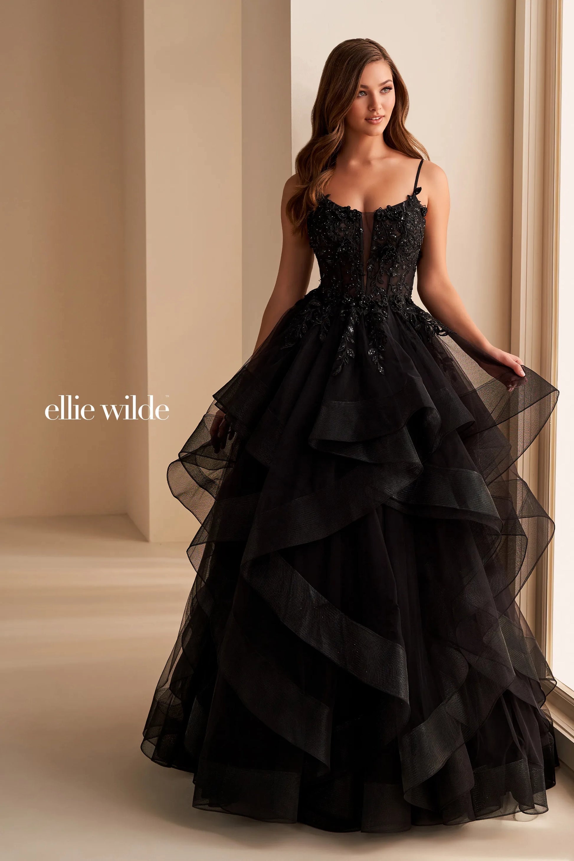 Step into elegance with the Ellie Wilde EW36225 Sheer Lace Corset Ball Gown. Featuring a stunning sheer lace bodice and layered corset, this formal evening gown is perfect for prom or any special occasion. Make a statement in this luxurious and exclusive dress, designed to make you feel like a work of art.