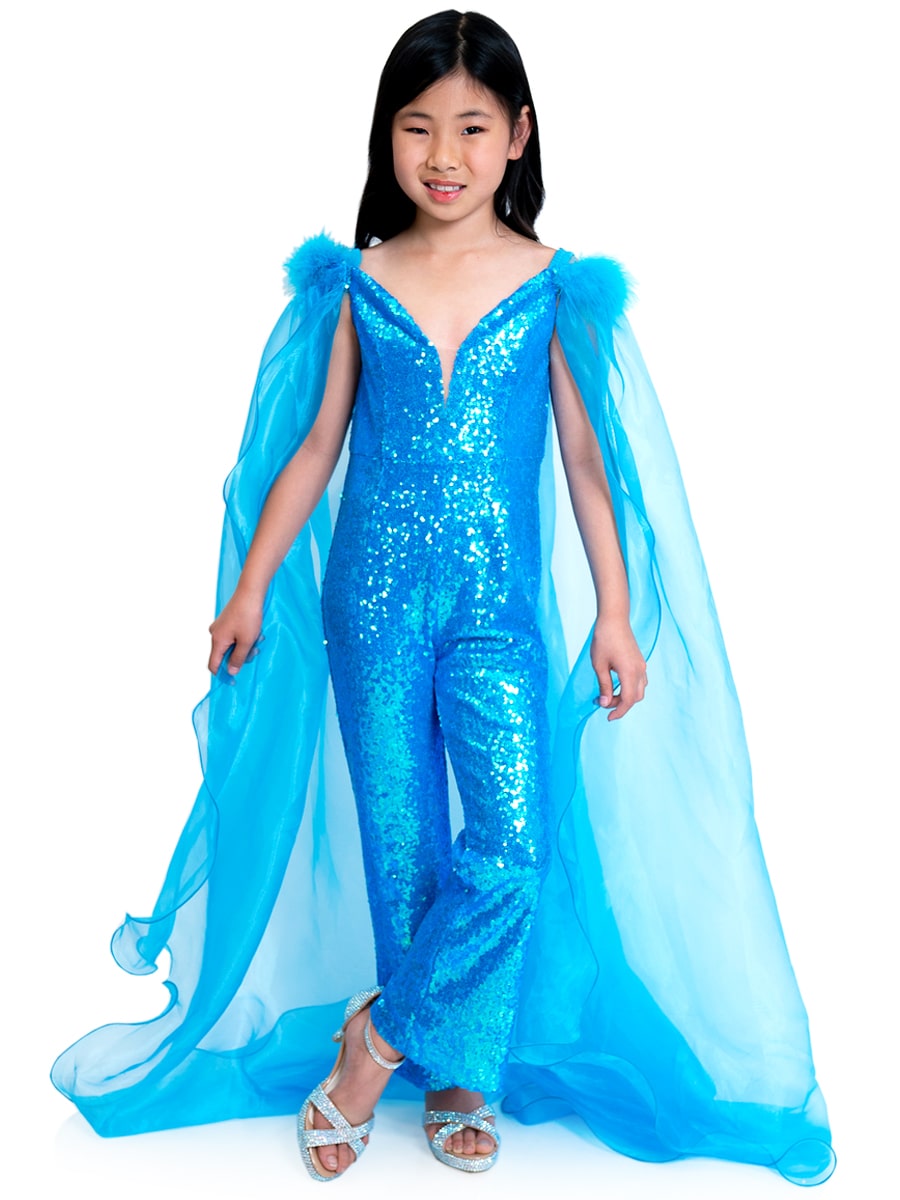 Marc Defang 8099K is a KIDS long pageant formal wear jumpsuit that is made of sequins and has off the shoulder straps.  The straps are attached to a cape with feathers at the shoulders.  Wow the crowd at your next pageant.  Available colors:  Pink, Turquoise, White, Black, Royal